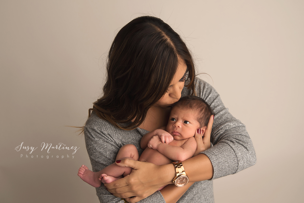 baby boy with mother during newborn portraits with Susy Martinez Photography