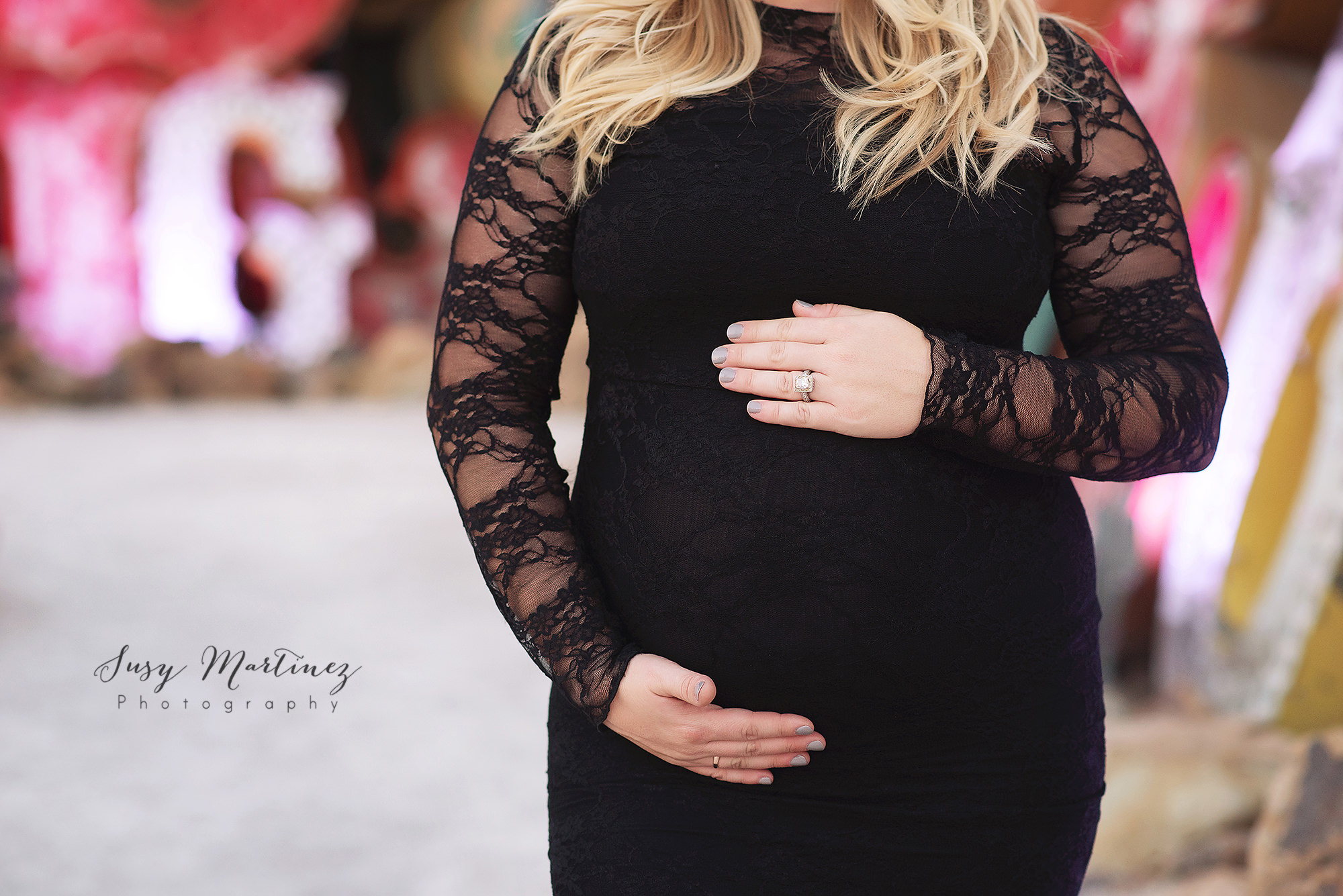 mom holds belly during maternity session with Susy Martinez Photography