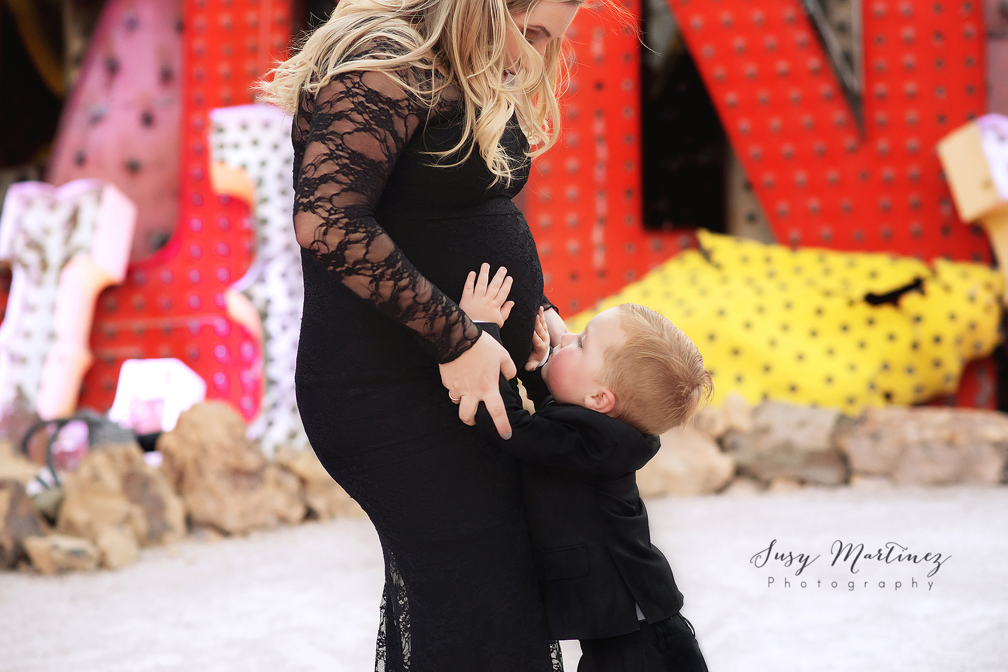 little brother touches mom's belly during Las Vegas maternity session with Susy Martinez Photography