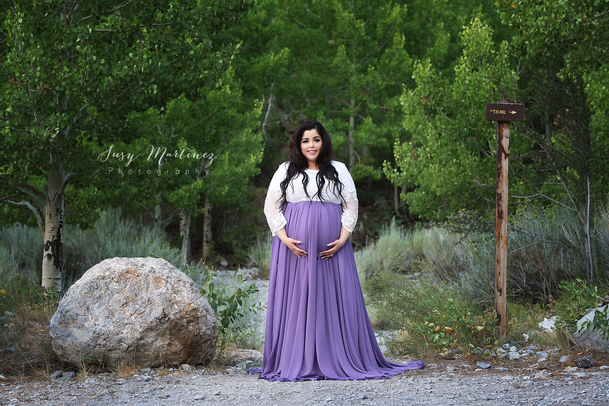 mom in purple and white gown poses for Susy Martinez Photography