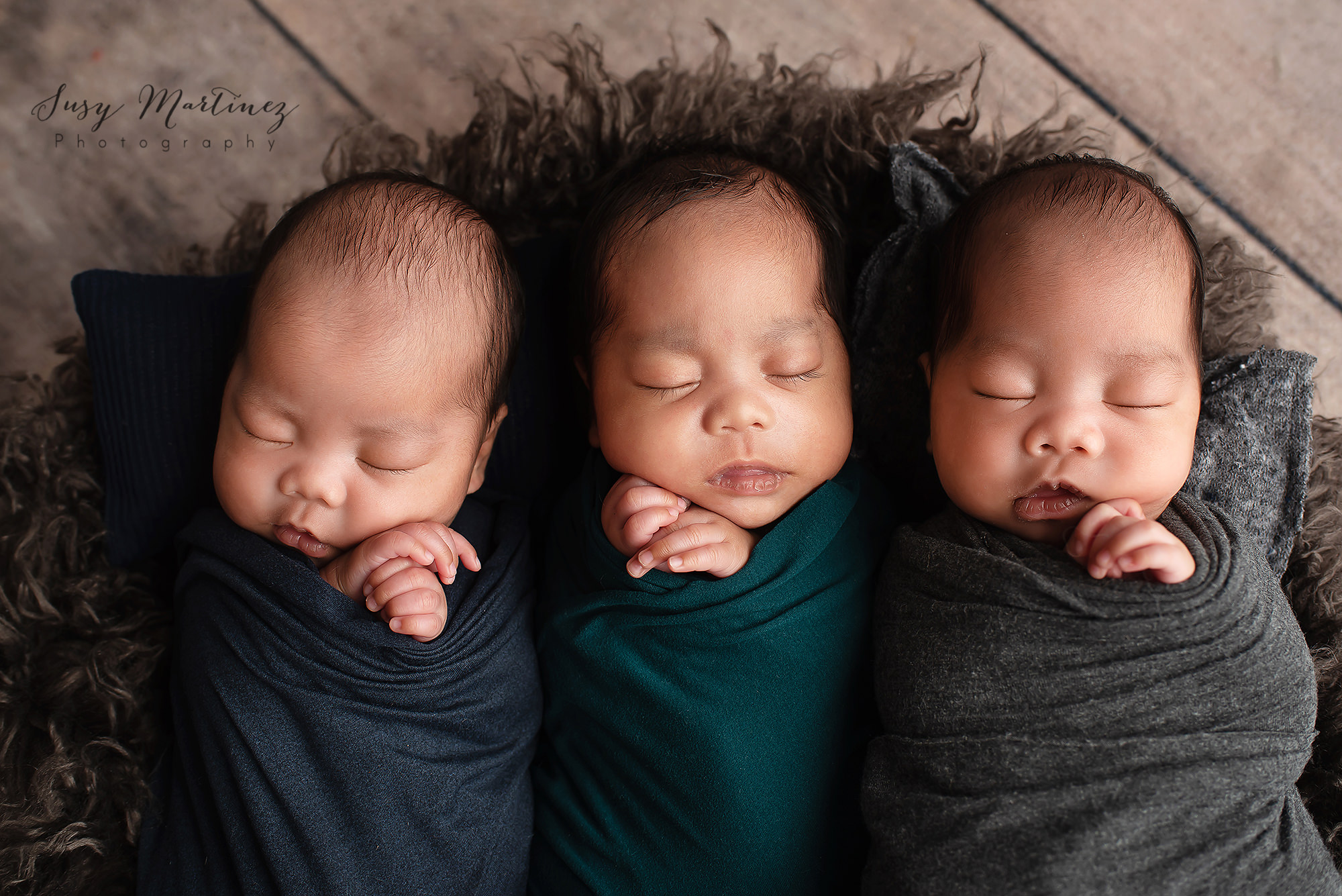 newborn session with triplets with dark color scheme photographed by Susy Martinez Photography