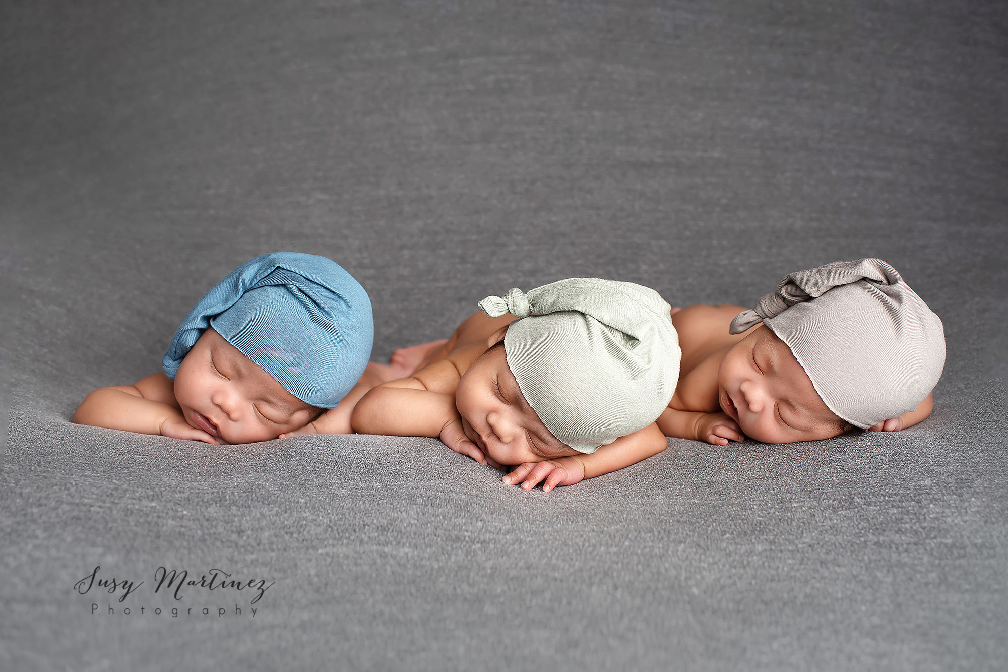 three newborn babies sleep in Las Vegas studio during newborn portraits