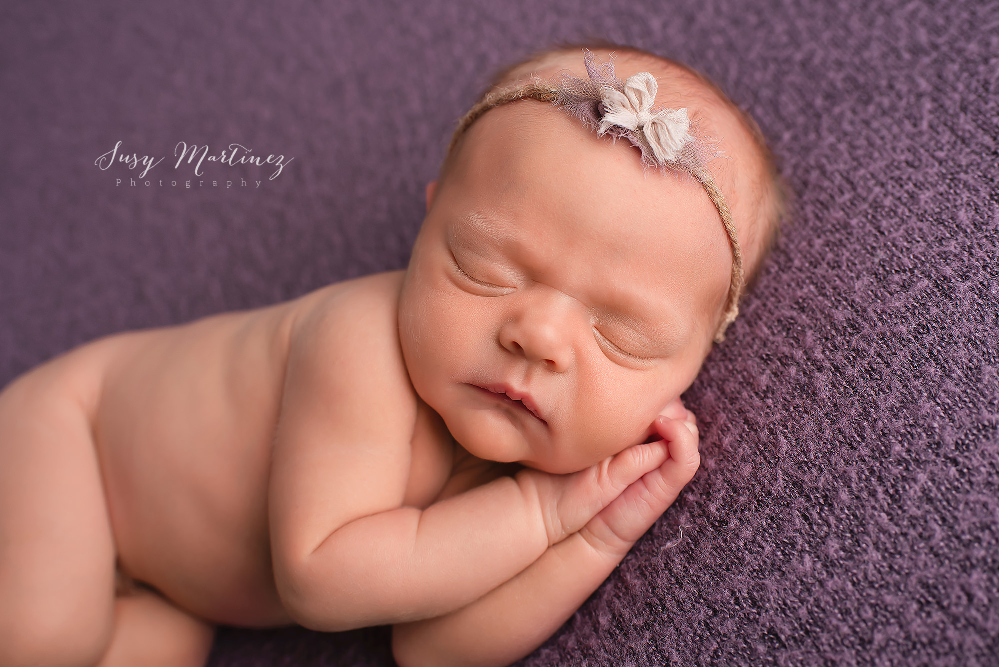 Henderson Newborn Photographer photographs baby girl on purple blanket