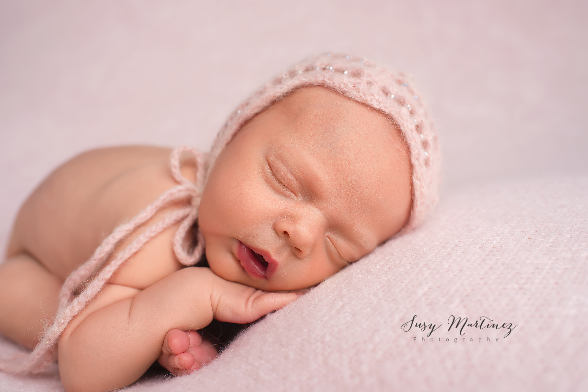 baby girl in knit cap poses for Pastel Newborn Mini Session
