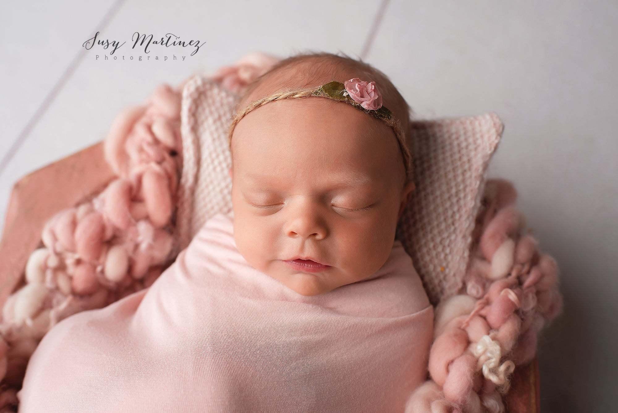 newborn session with Henderson newborn photographer for baby girl with flower in hair
