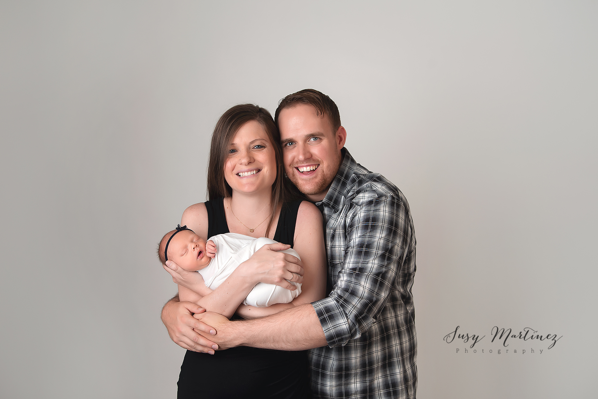 Henderson Newborn Photographer photographs new parents with baby girl