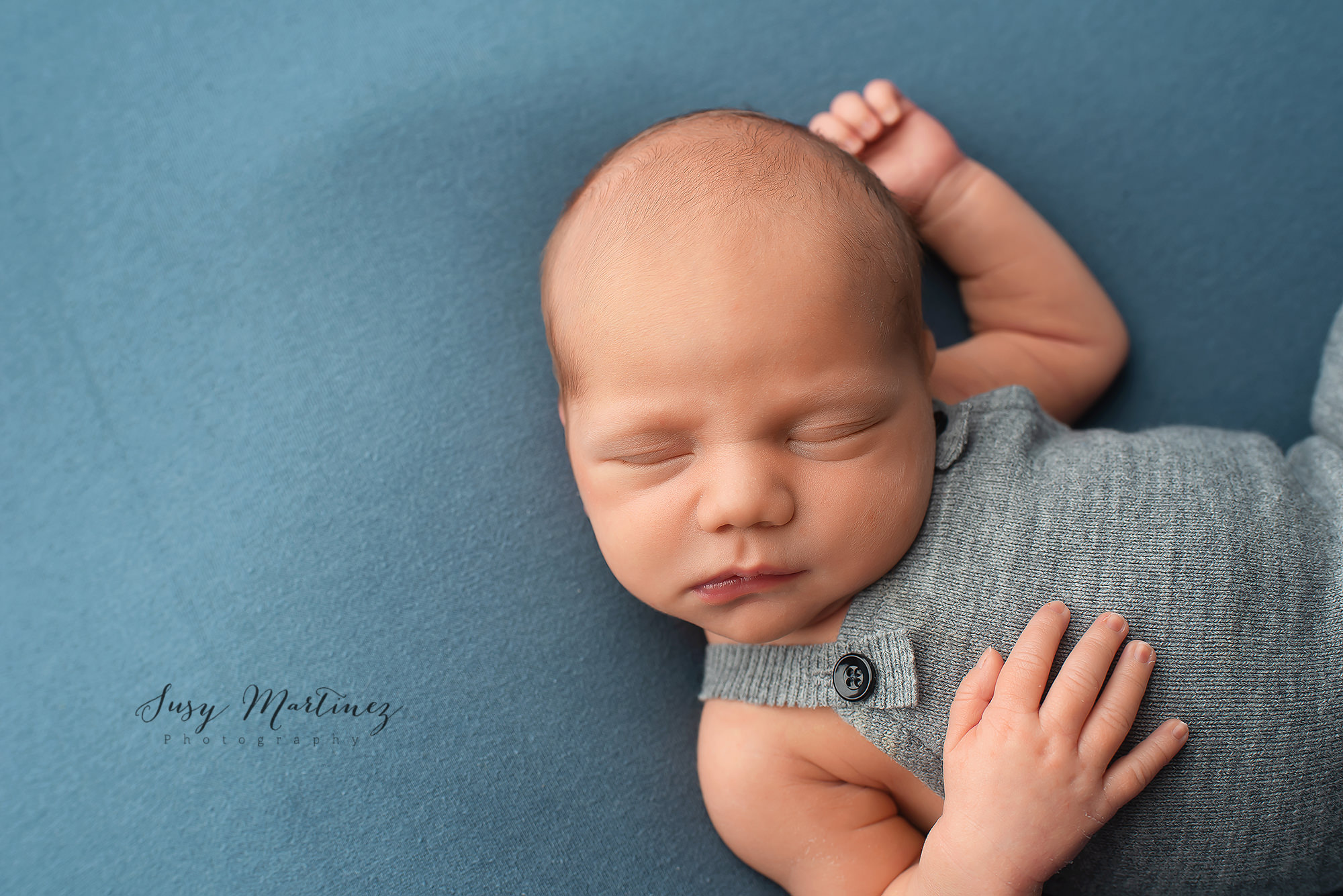 baby in grey knit jumper sleeps during NV newborn session with Henderson Newborn Photographer Susy Martinez Photography