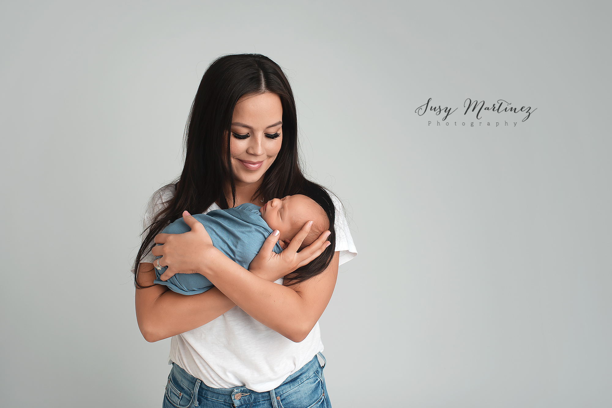 mom holds new baby boy during newborn mini session with Henderson Newborn Photographer Susy Martinez Photography
