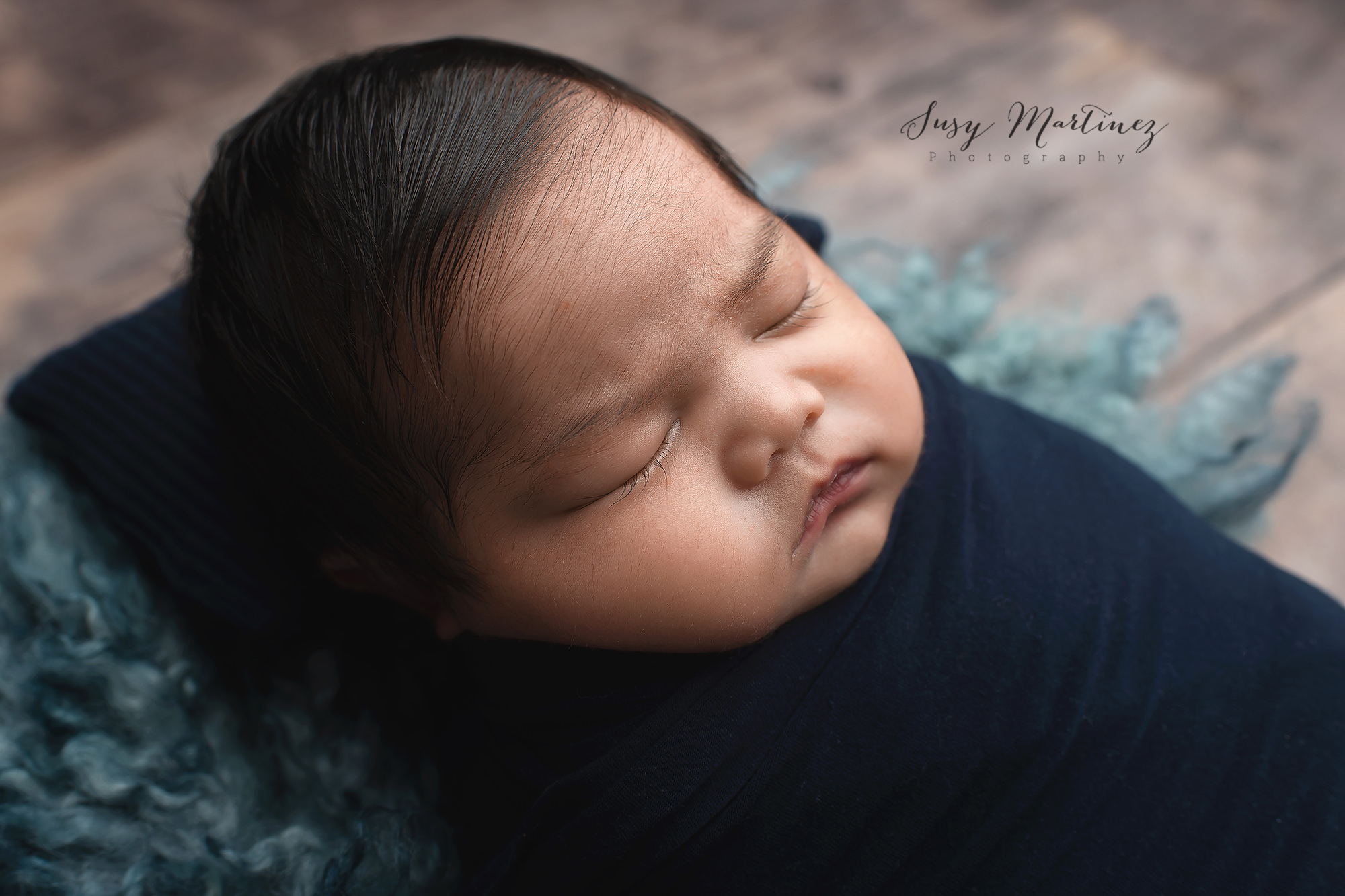 Henderson Newborn Photographer captures baby boy sleeping on blue floki