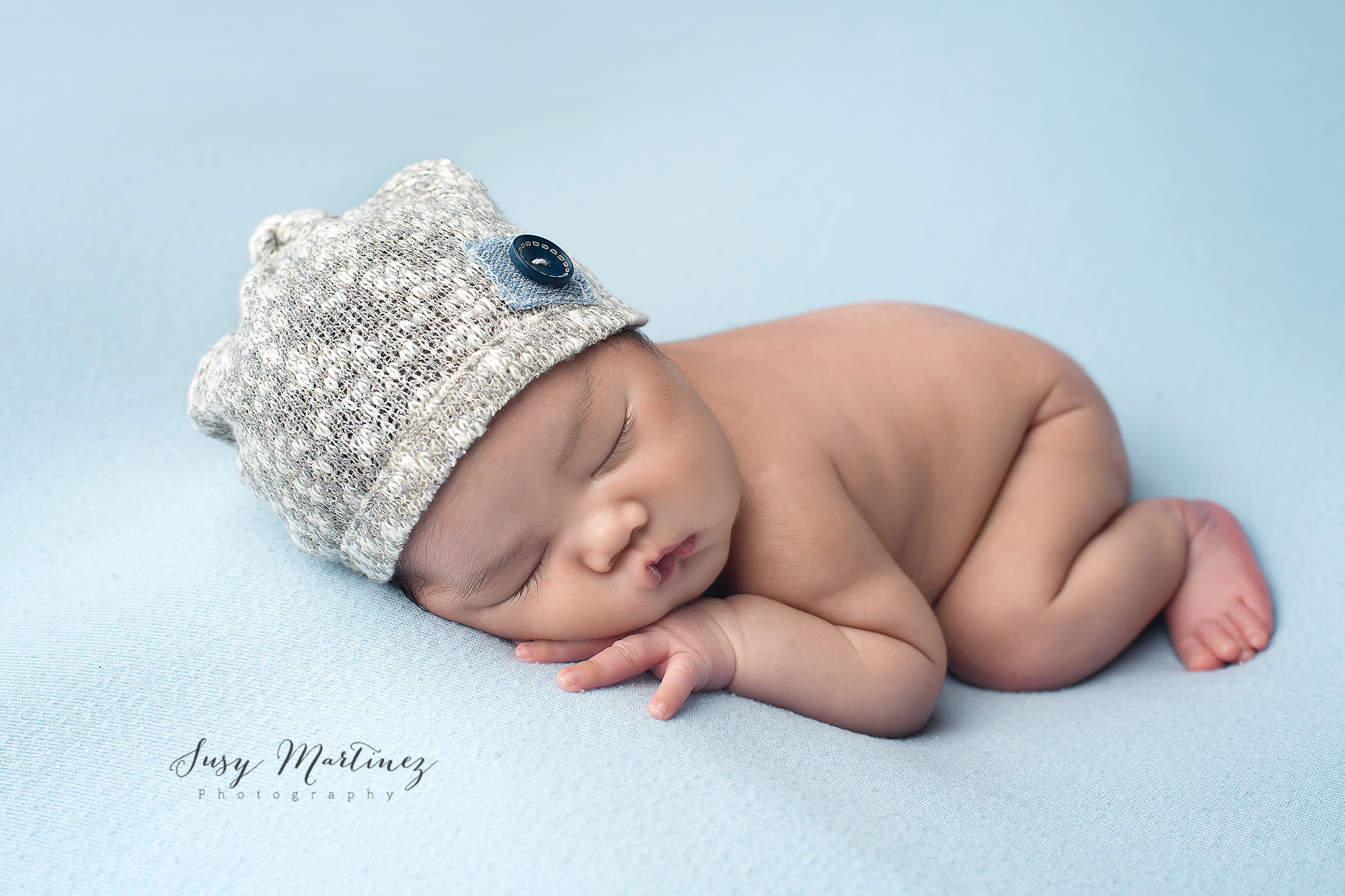 Studio Newborn Portraits in Las Vegas with baby in knit cap