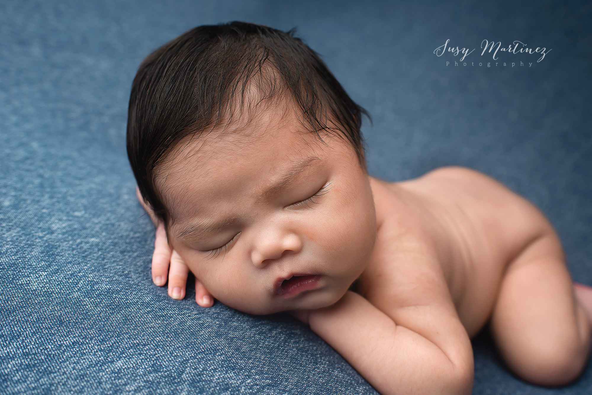 baby boy sleeps on denim blue drop during Studio Newborn Portraits in Las Vegas