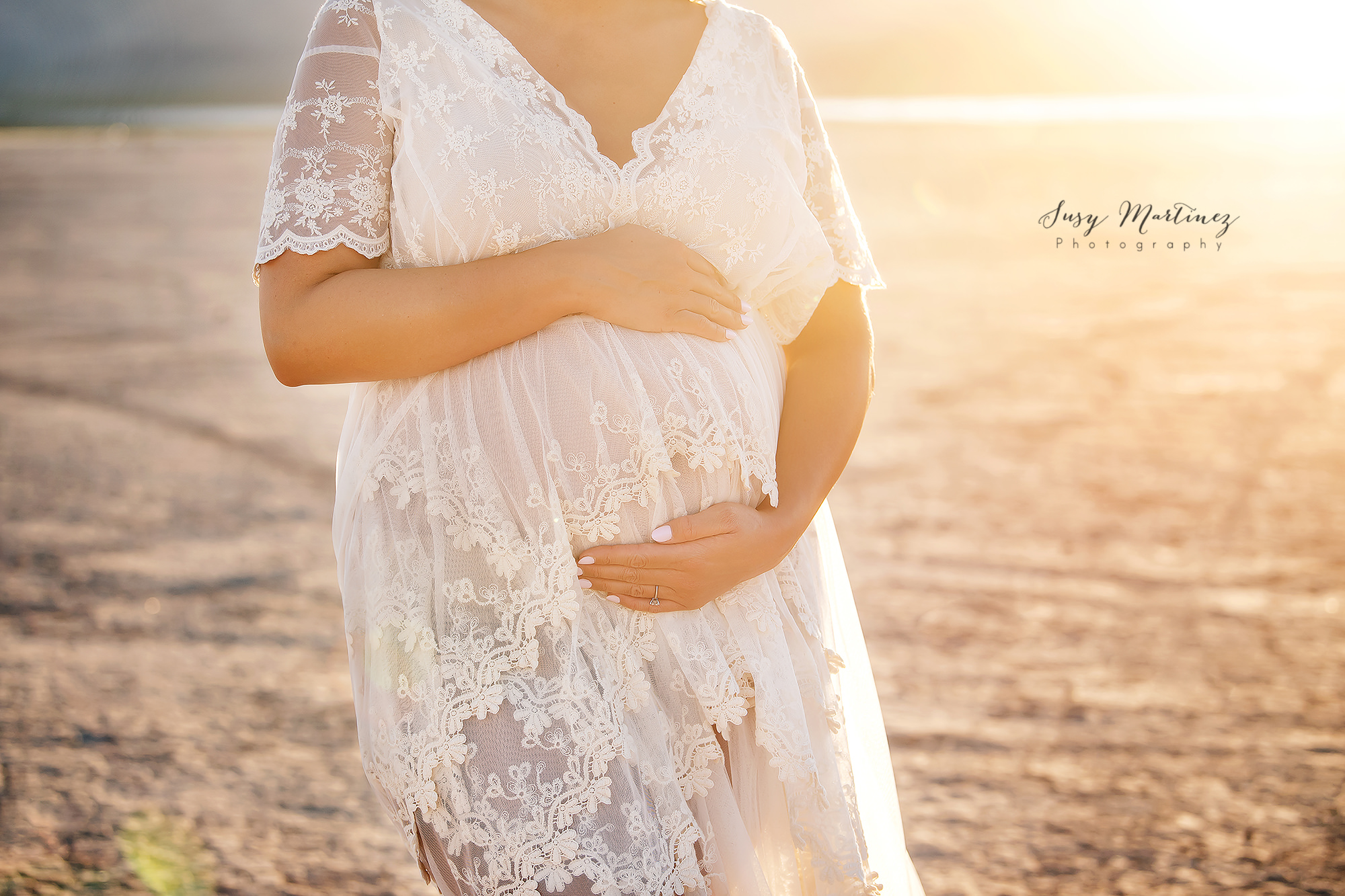 mom holds belly during maternity session wearing Sew Trendy Accessories Boho River Gown