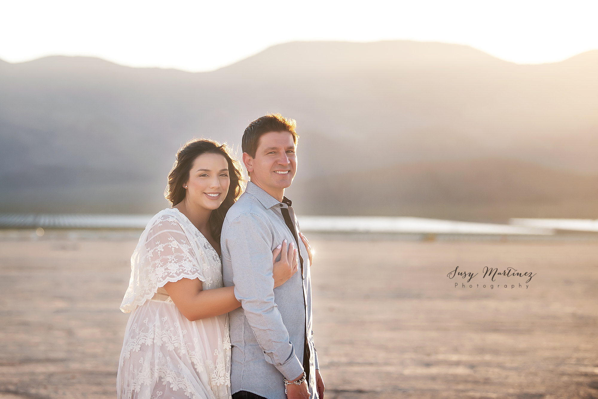 parents pose in Las Vegas Dry Lake Bed during maternity session