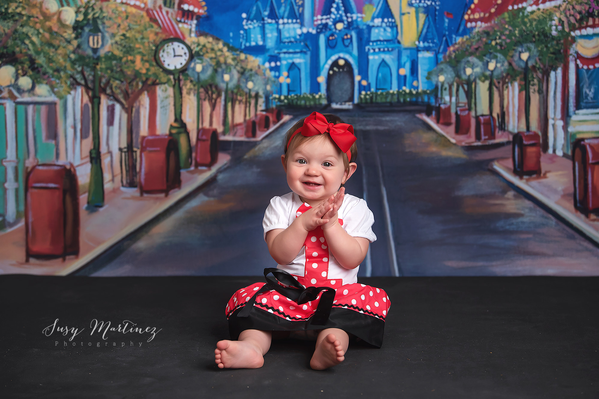 Main Street USA milestone portraits with baby girl in Minnie Mouse outfit