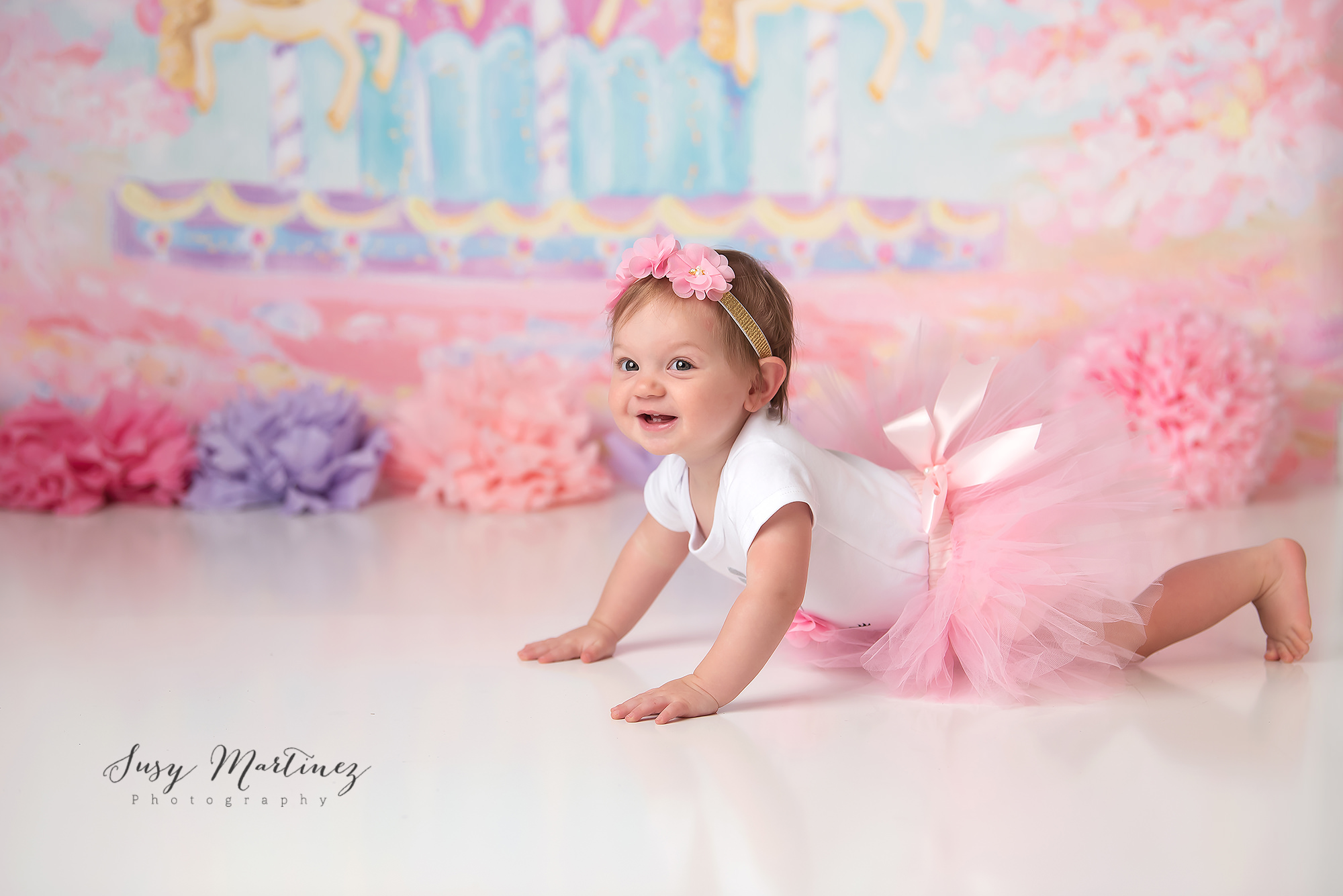 baby crawls during milestone portraits for first birthday