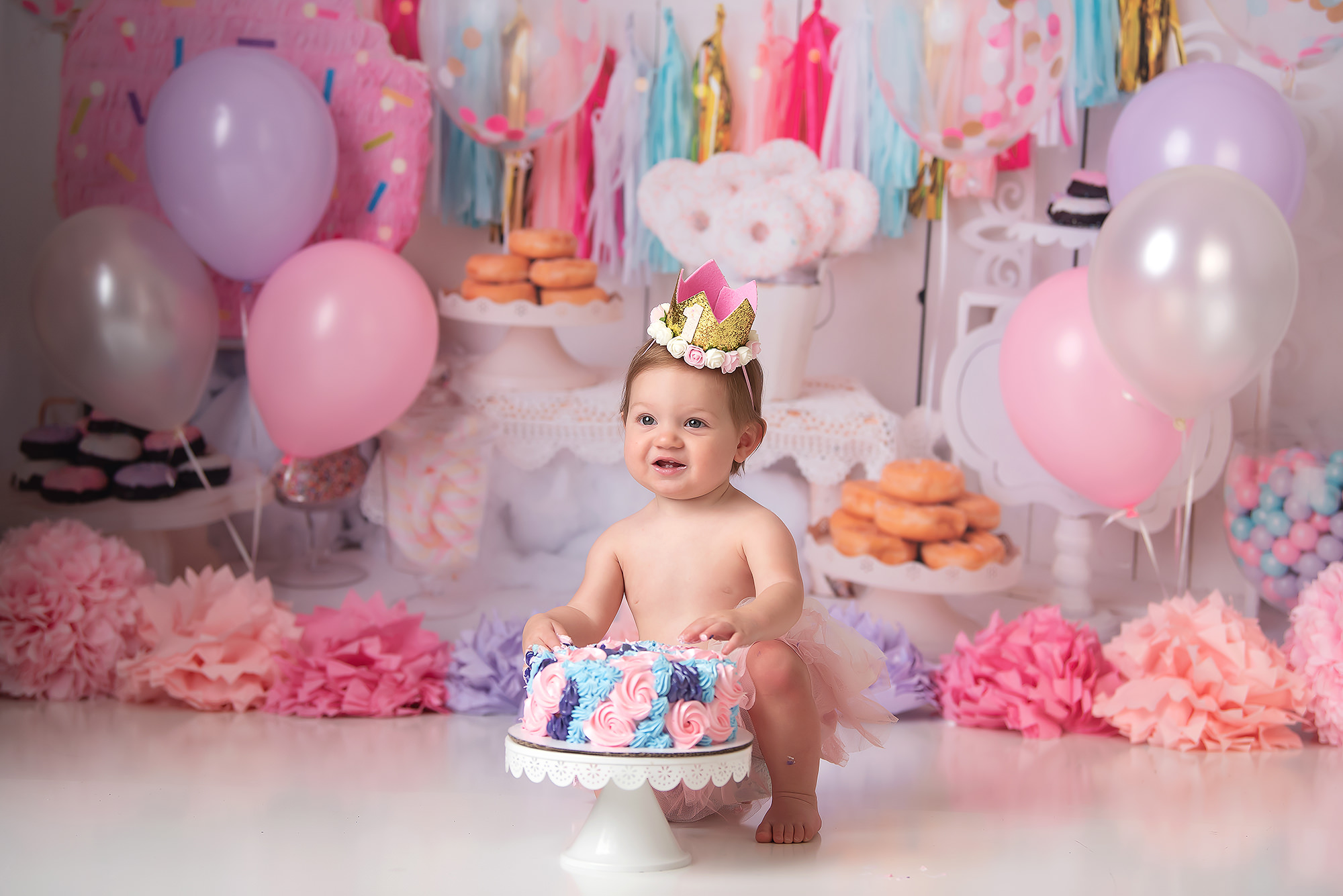 pastel cake smash with donuts on backdrop for first birthday