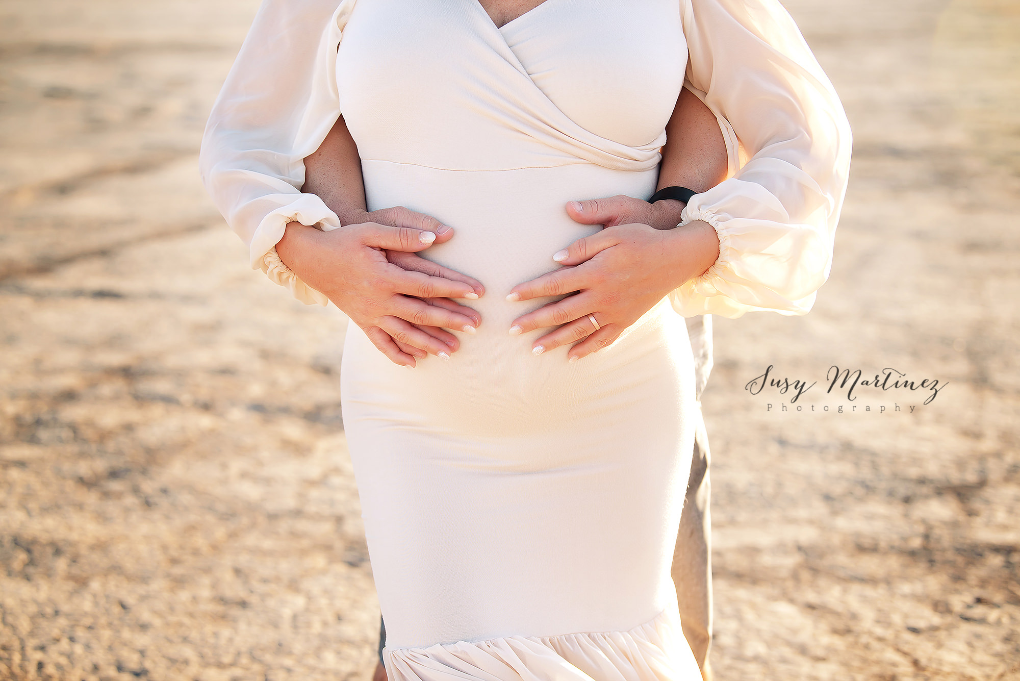 mom and dad hold mom's belly during Las Vegas maternity session