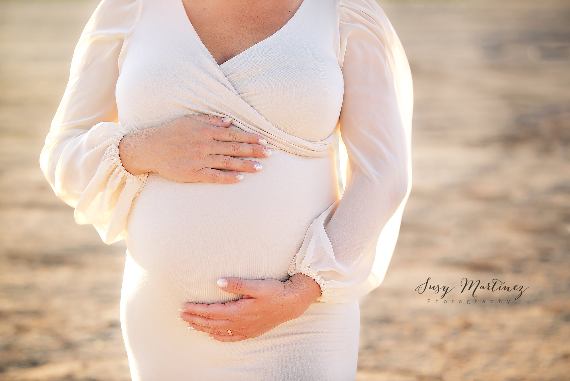 mom holds baby belly during Dry Lake Bed Maternity Photos