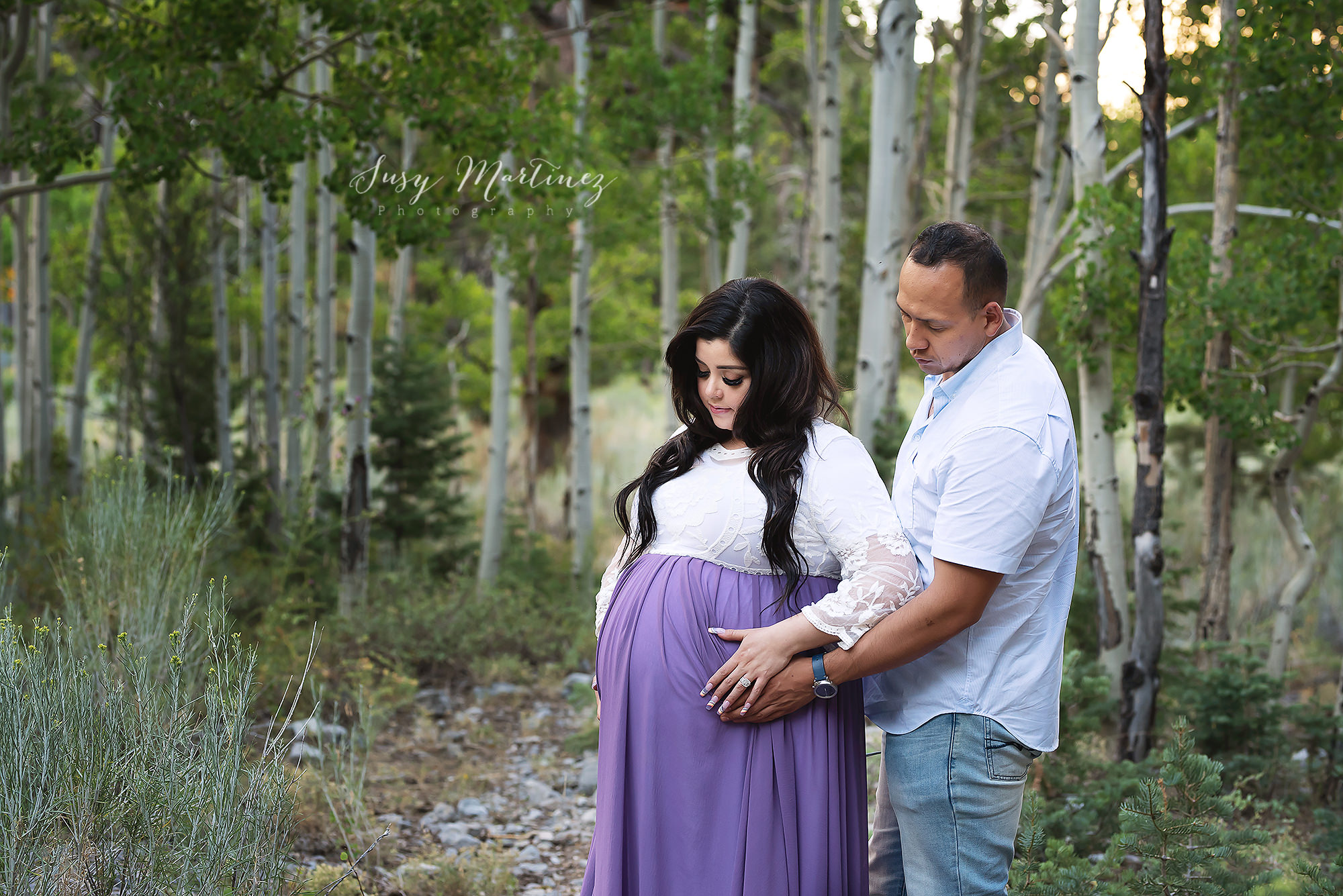 mom and dad touch mom's belly during mountain maternity portraits in Las Vegas