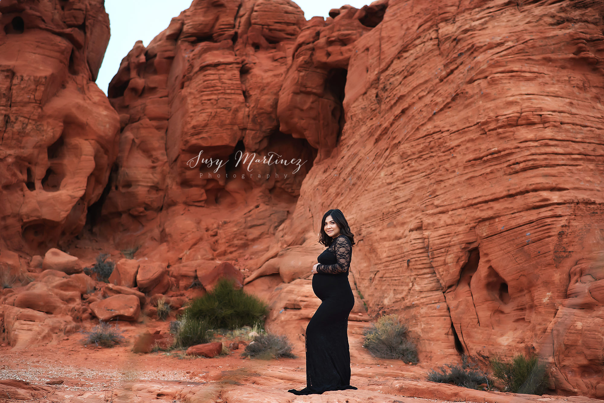 mom poses in lace Sew Trendy Accessories gown in the Valley of Fire