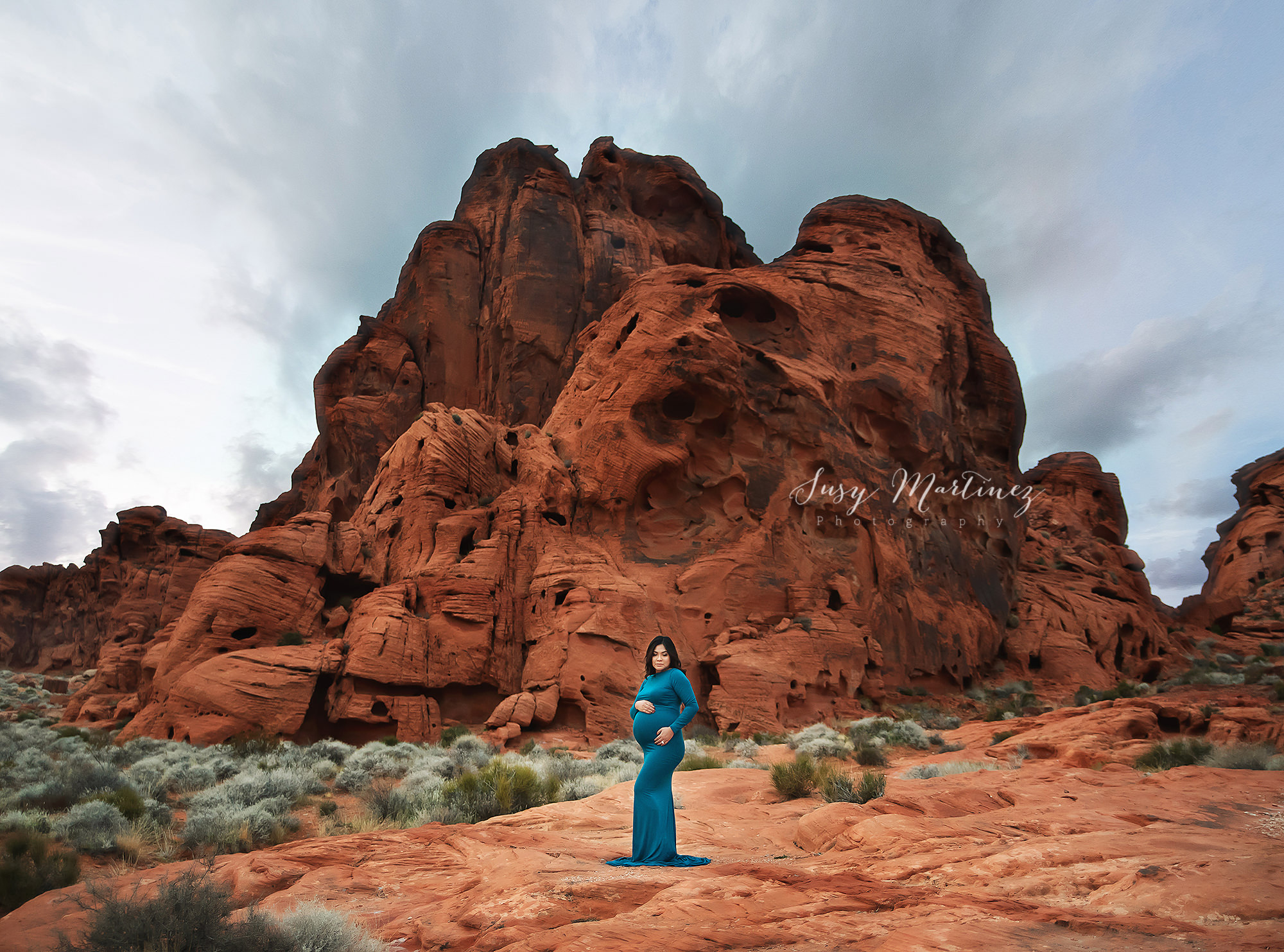 Valley of Fire maternity portraits on overcast day with mom in teal gown