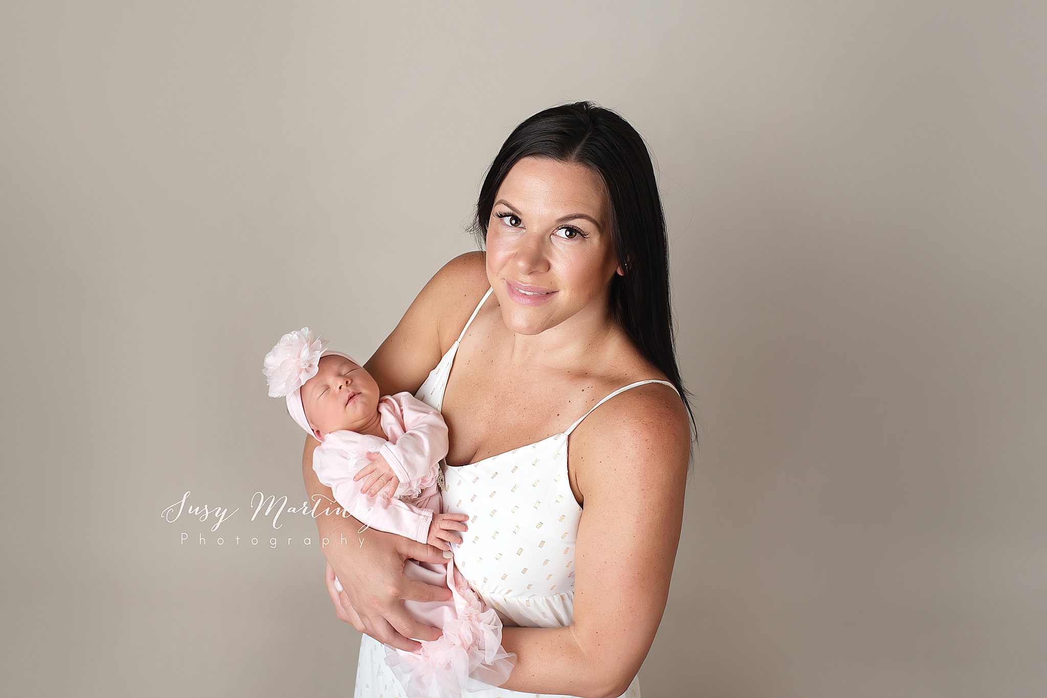 mom holds new baby girl during newborn portraits in Las Vegas