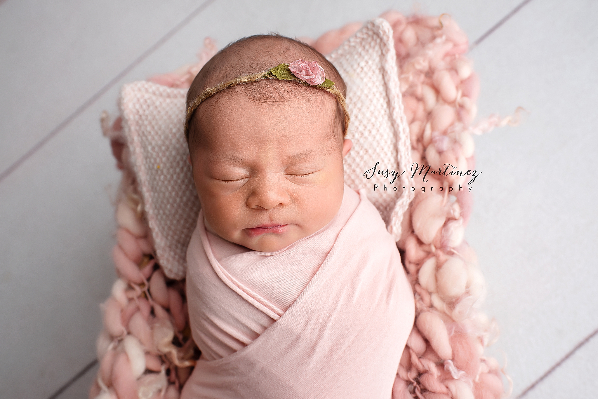 baby girl sleeps on pink pillow during studio newborn session in Las Vegas