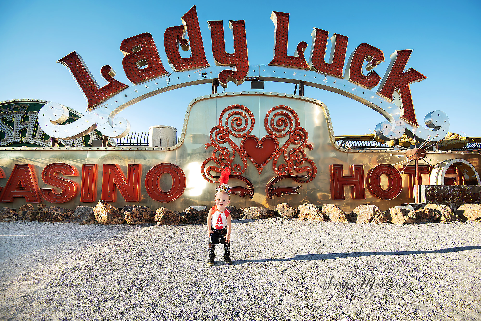 toddler poses by Lady Luck Casino sign in North Gallery of Neon Boneyard
