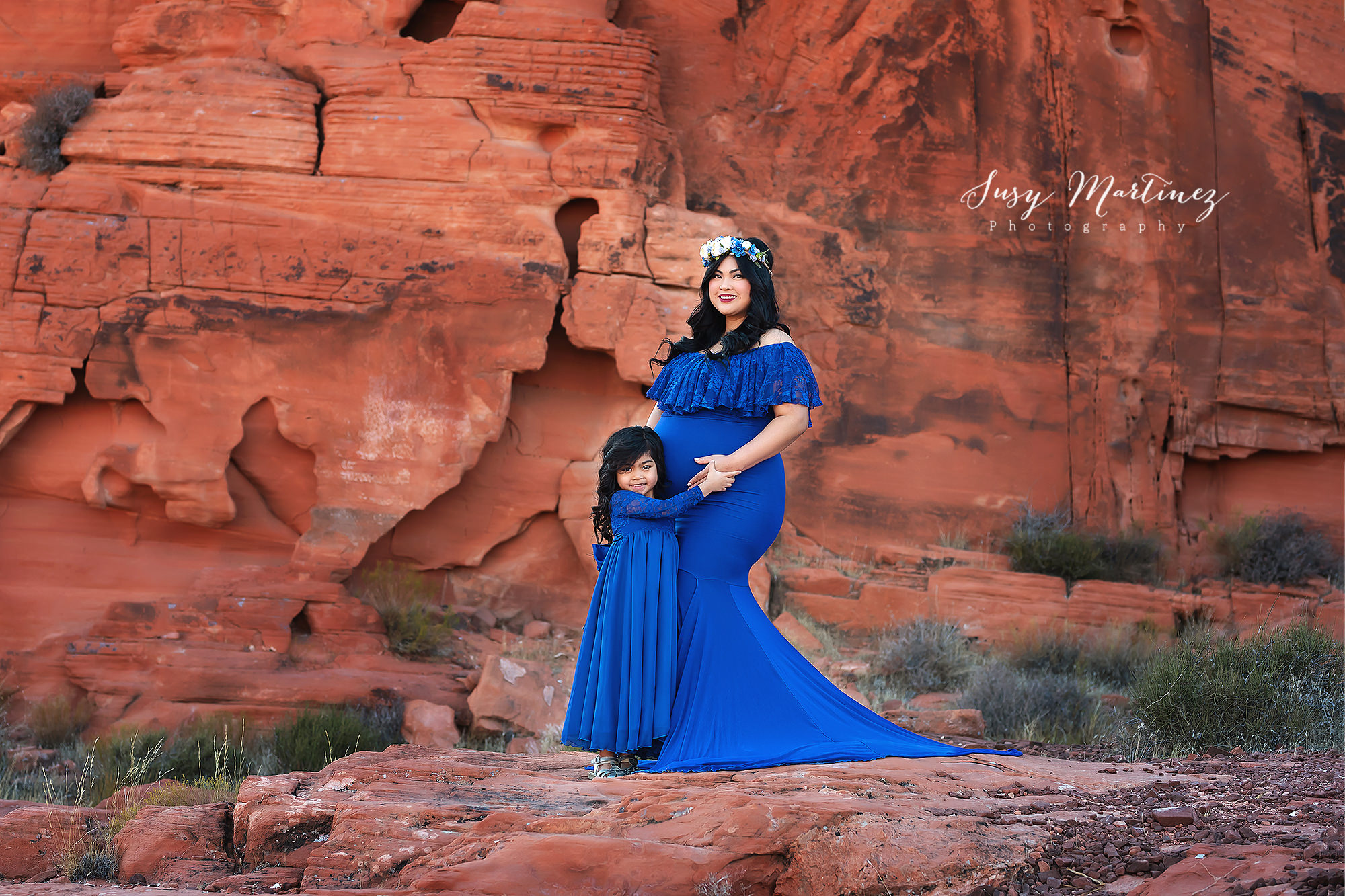 mom and daughter pose in blue Sew Trendy Accessories gowns during Valley of Fire Maternity Session