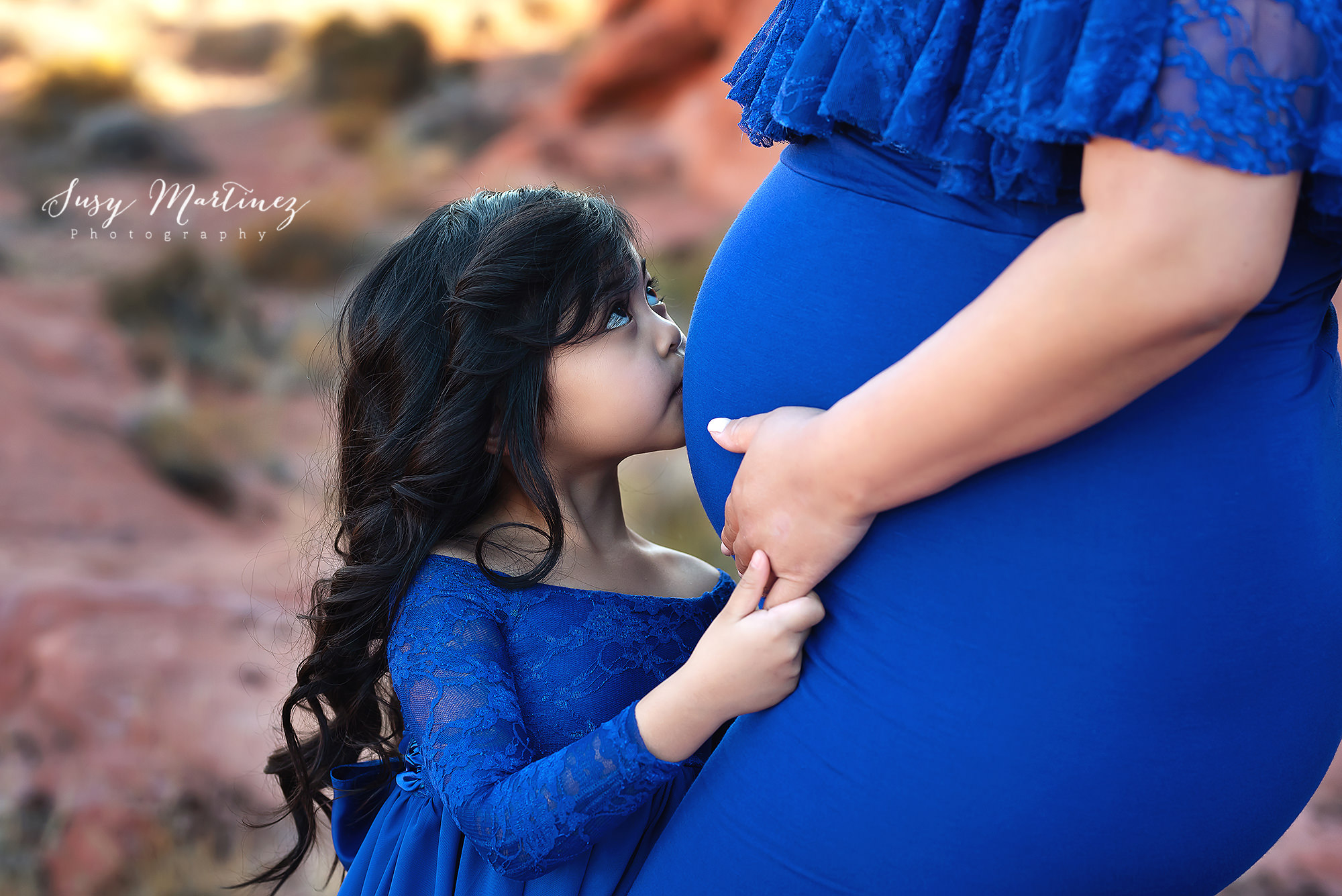 daughter kisses mom's belly during Valley of Fire Maternity Session