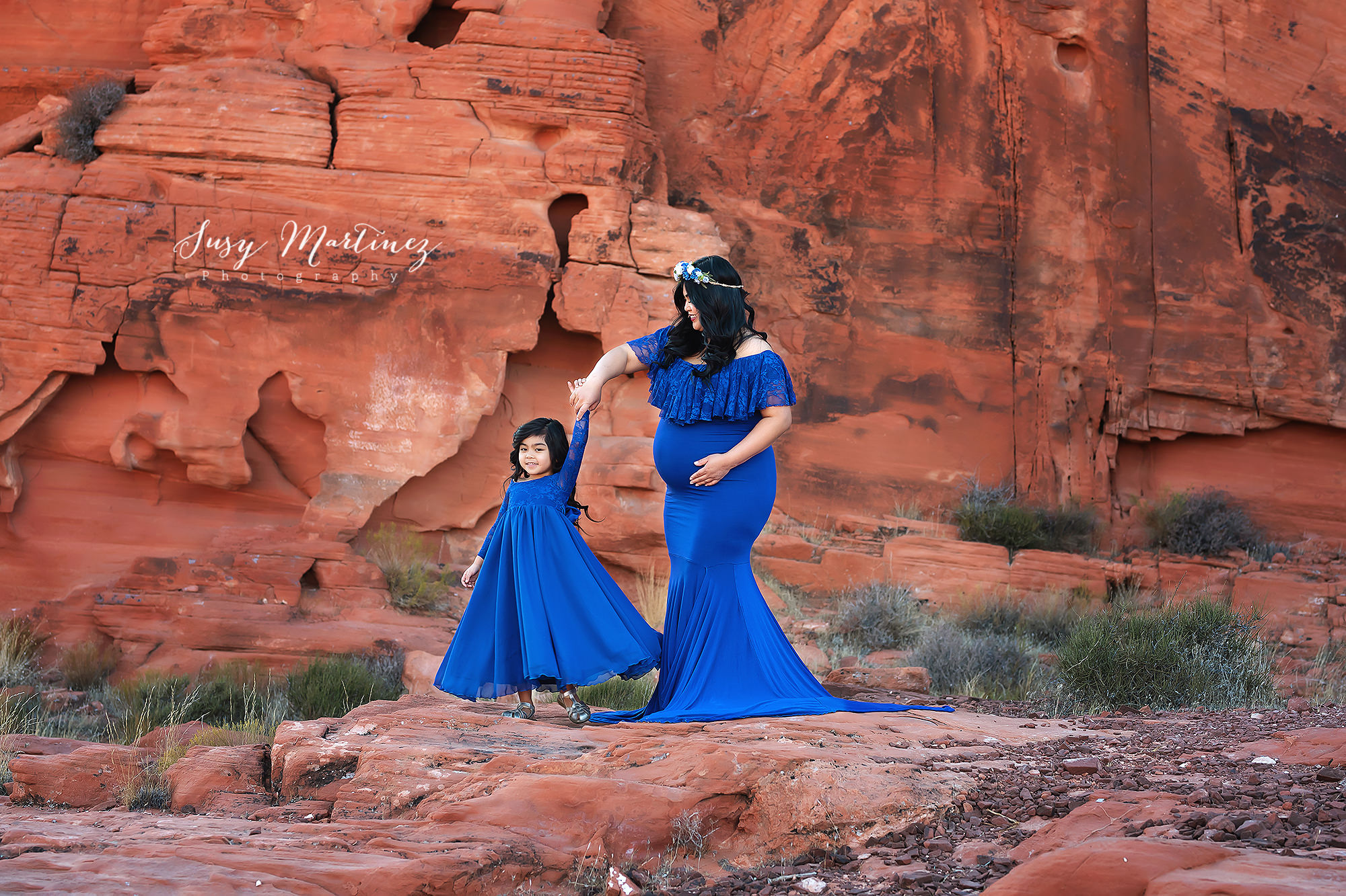 mom twirls daughter during Valley of Fire Maternity Session
