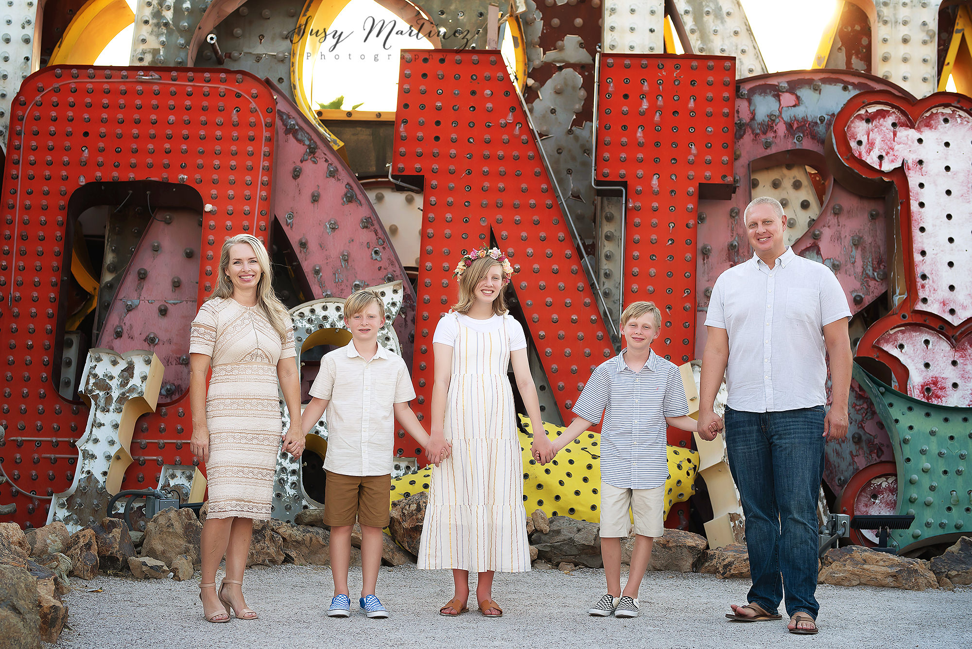 family of five poses in North Gallery of Neon Boneyard 