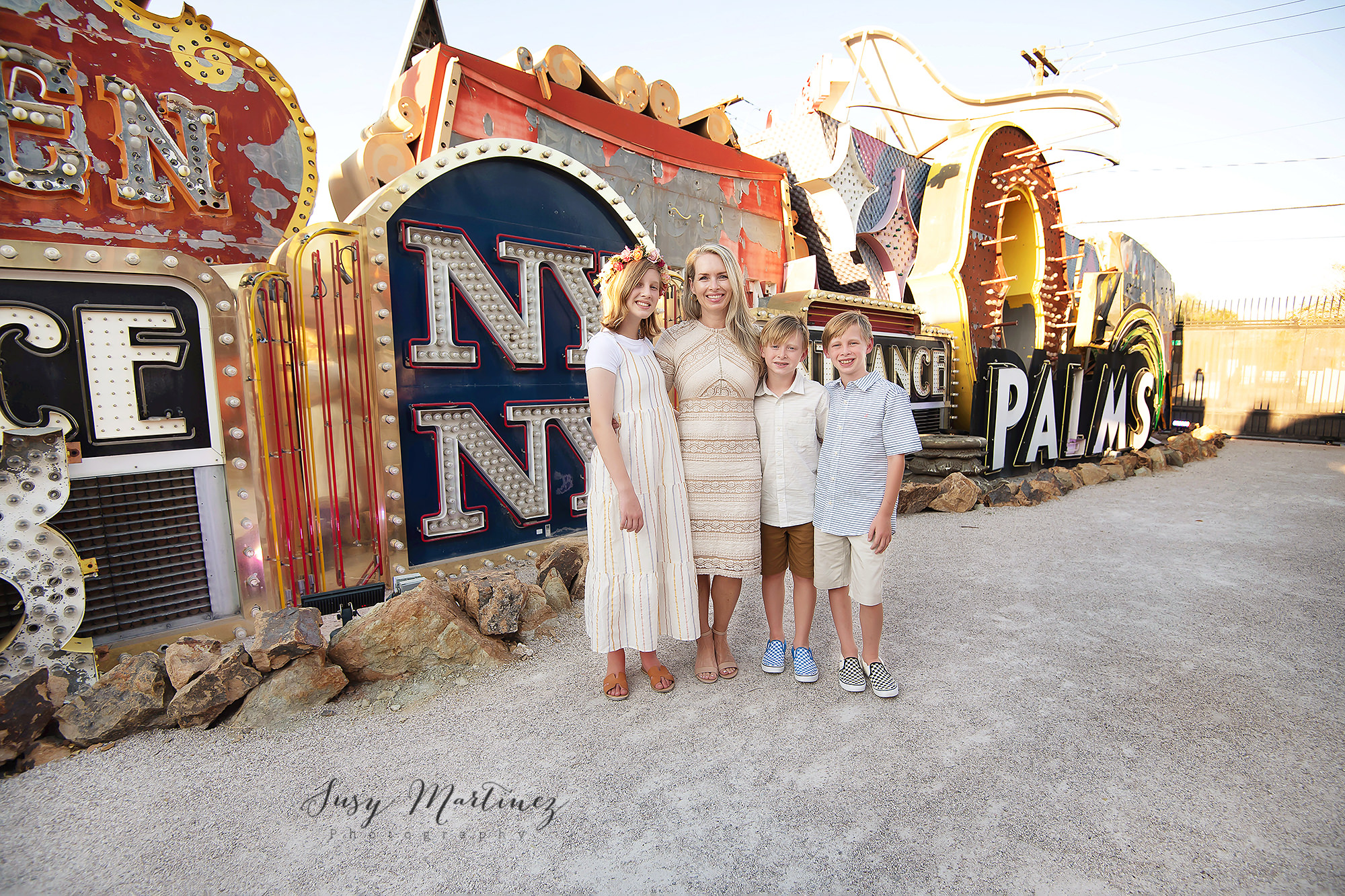 mom poses with three children during Las Vegas family portraits 