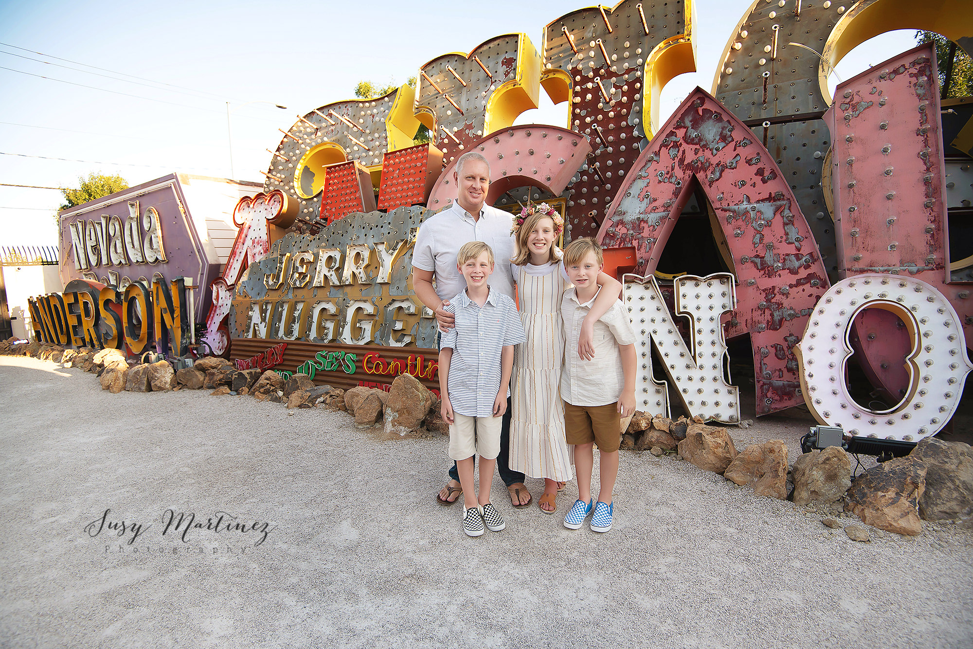 dad poses with three children during Neon Boneyard Family Portraits