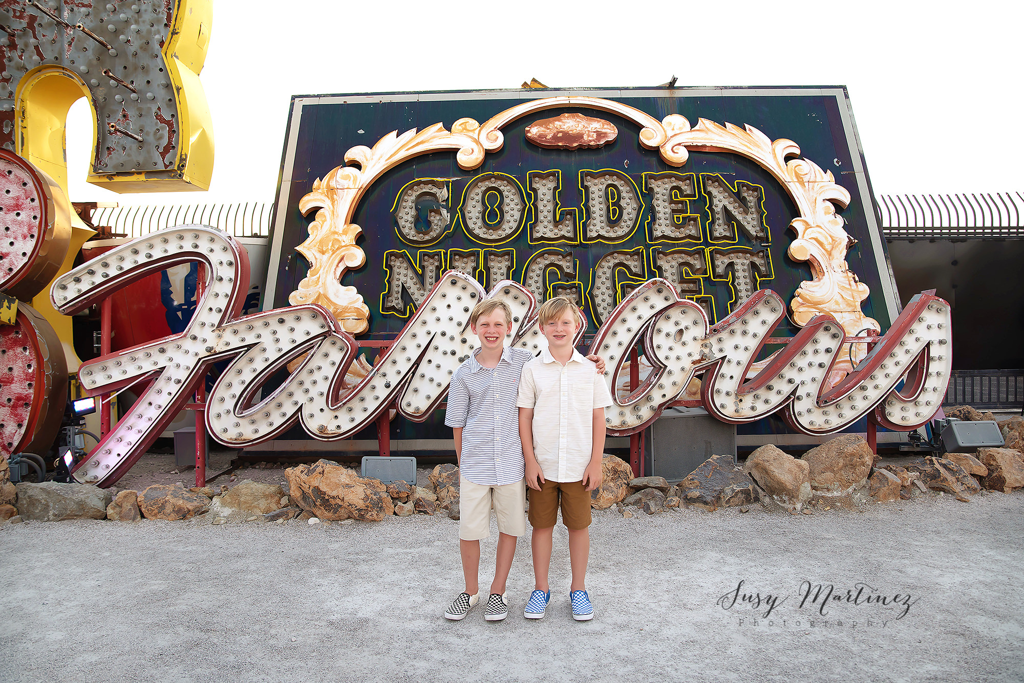 twin brothers pose together during birthday photos in Neon Boneyard