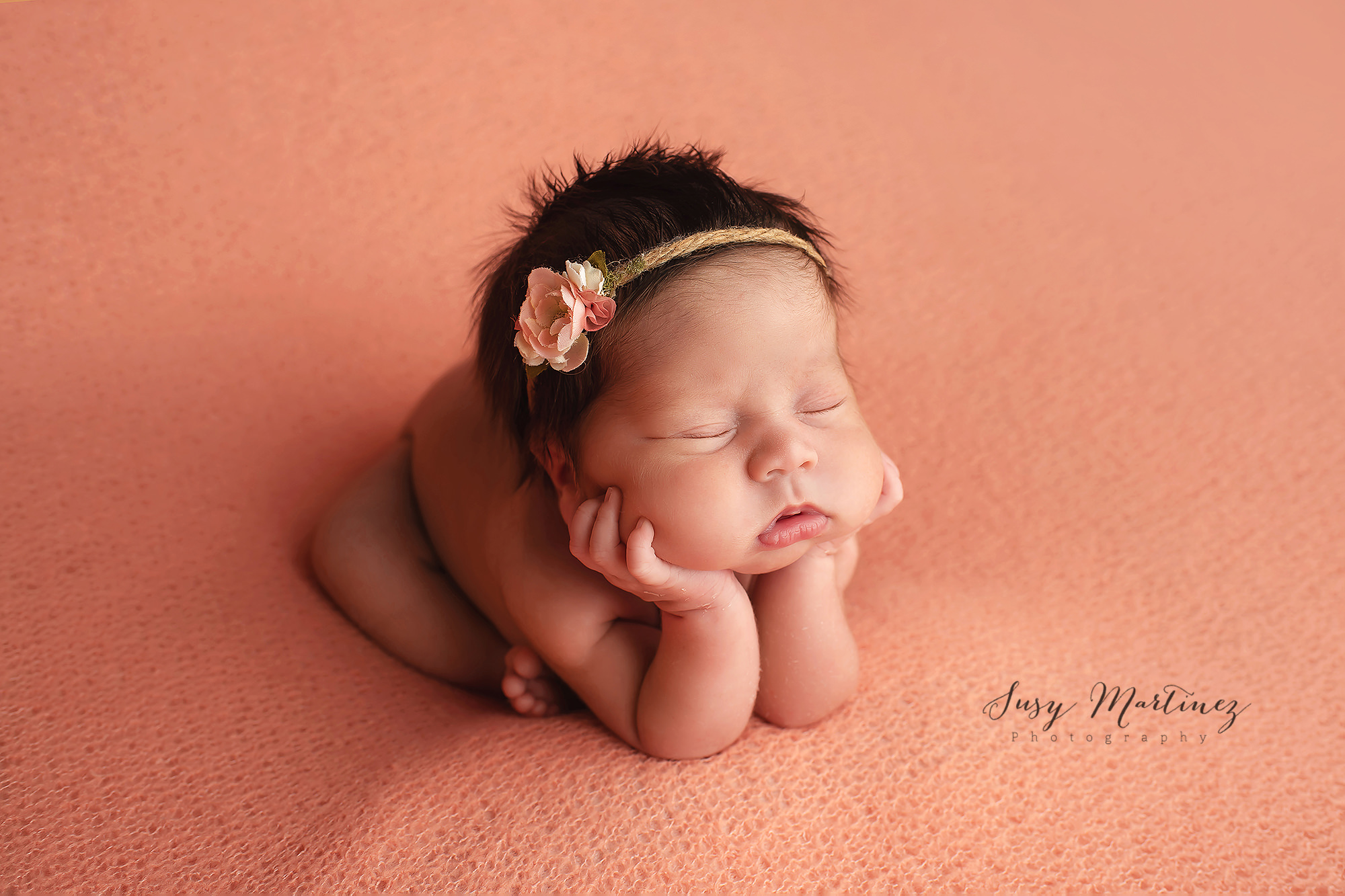 baby girl on pastel backdrop sleeps during newborn photos