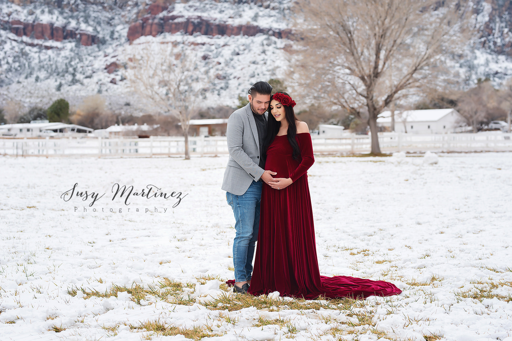 parents to be pose in snow at Spring Mountain Ranch during maternity photos