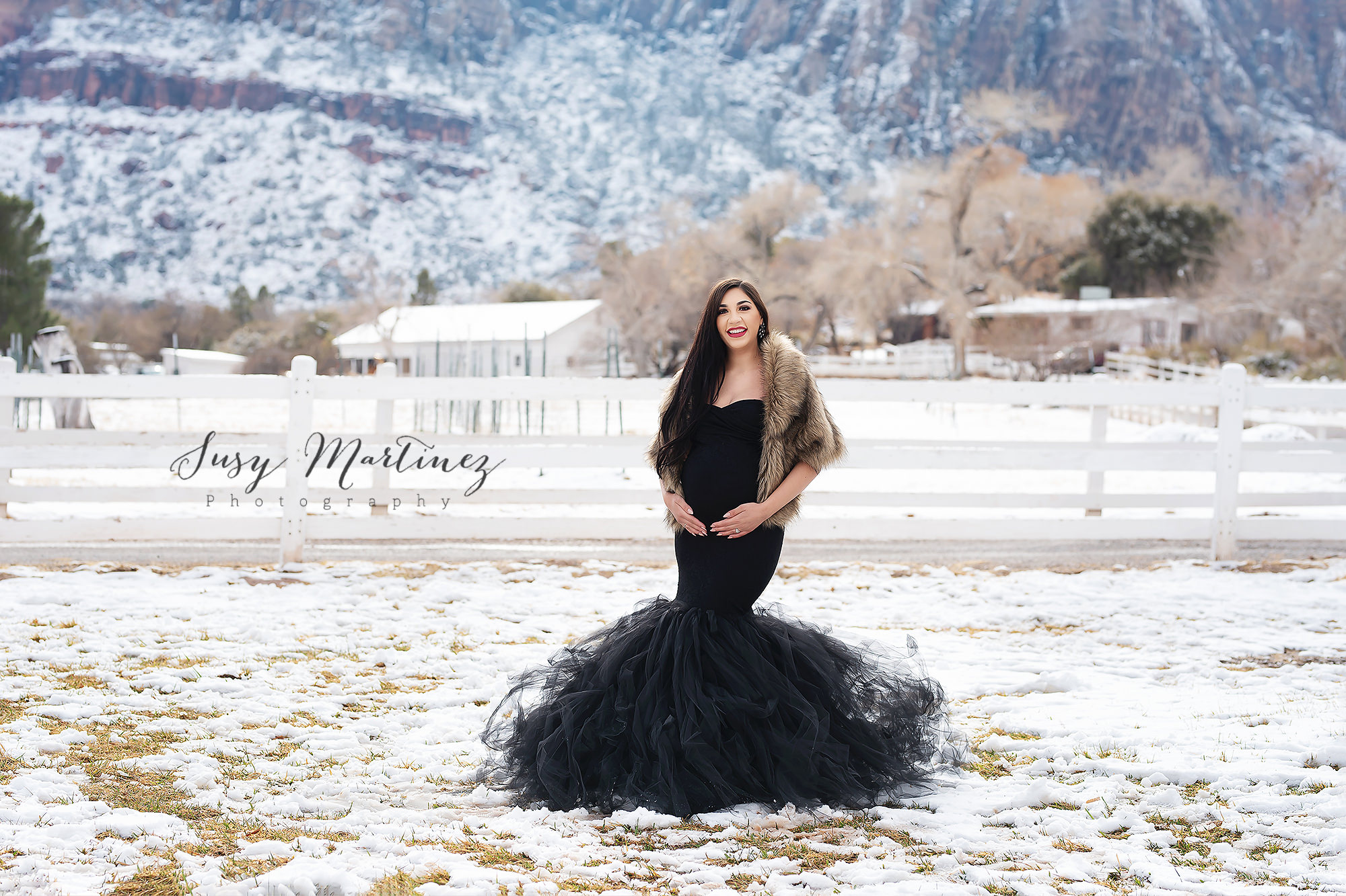 snowy Spring Mountain Ranch maternity portraits with mom in black dress