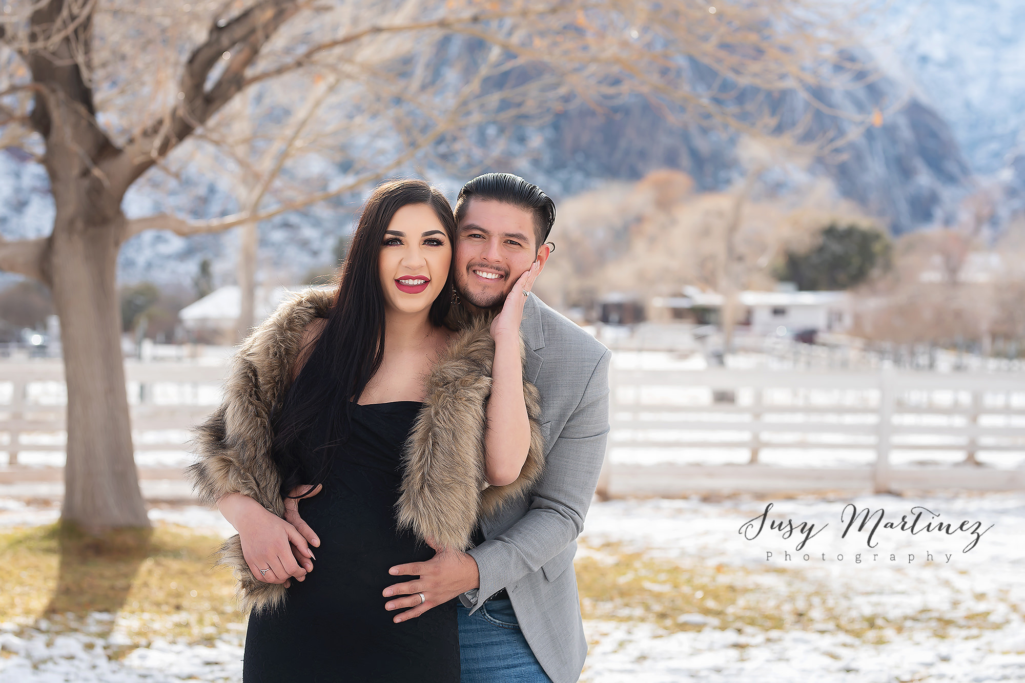 expecting couple hugs during snowy Spring Mountain Ranch maternity portraits 