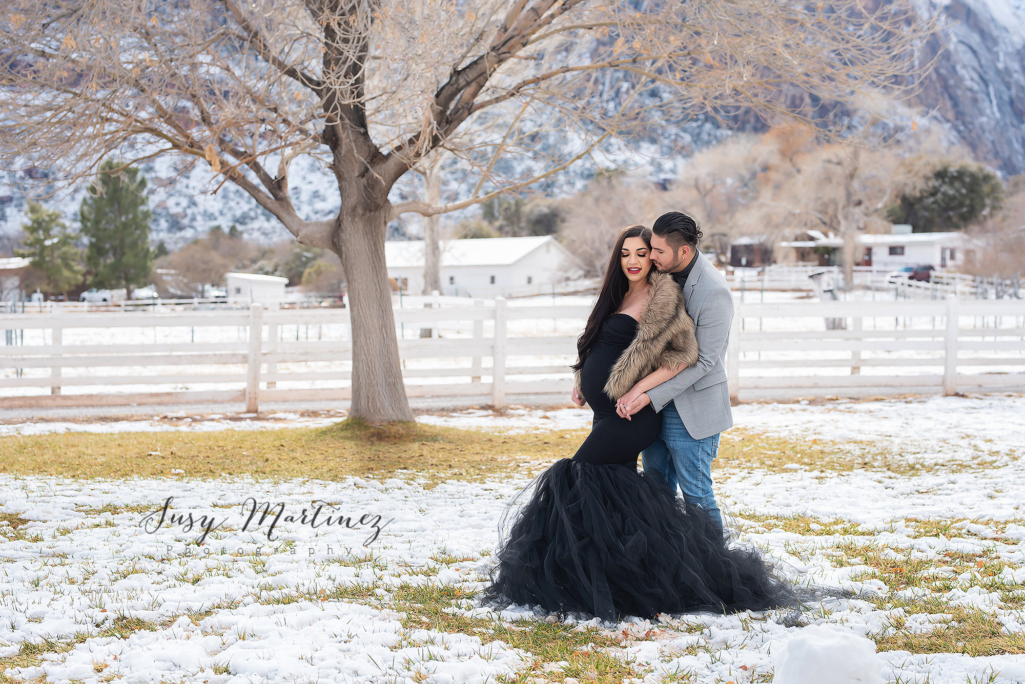 mama in black Sew Trendy Accessories gown poses with dad-to-be on Las Vegas ranch