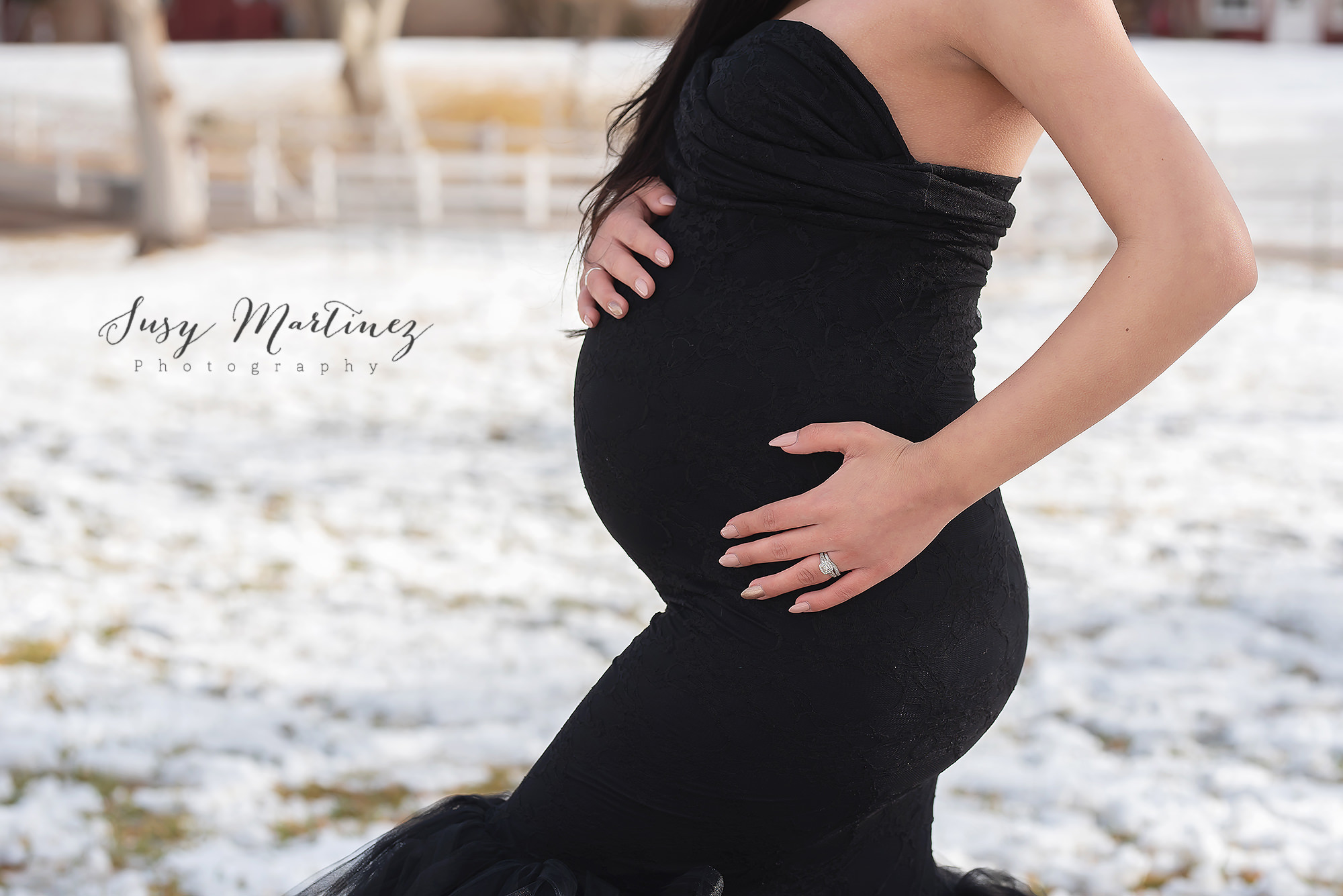 mom holds baby belly during maternity portraits in Las Vegas