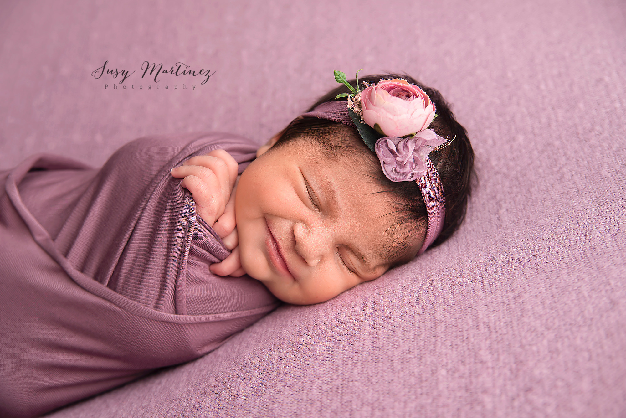 baby girl sleeps with pink floral headband during Las Vegas session