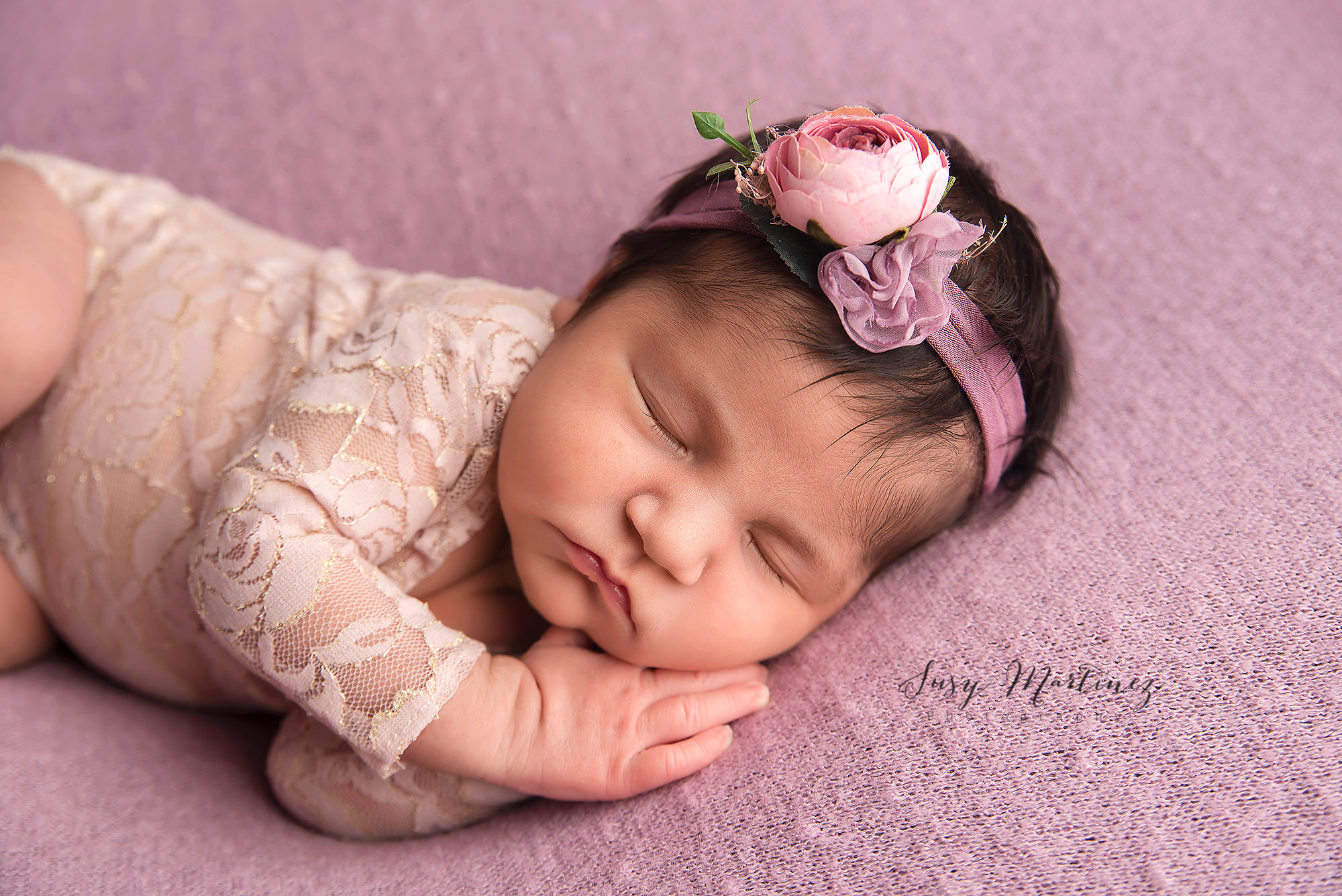 pastel themed newborn session for baby girl with pink and purple details