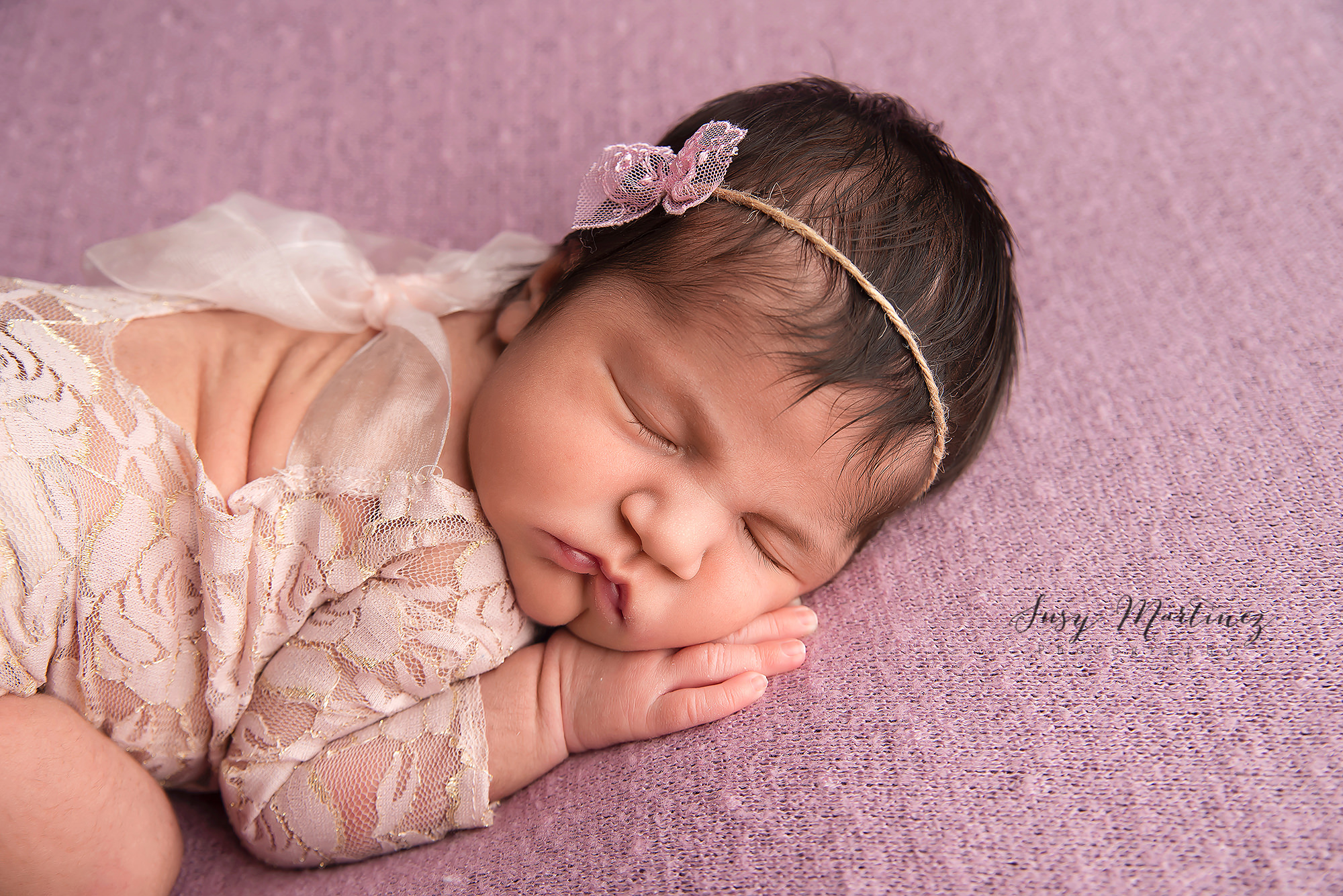 baby sleeps in lace outfit during Las Vegas pastel themed newborn session