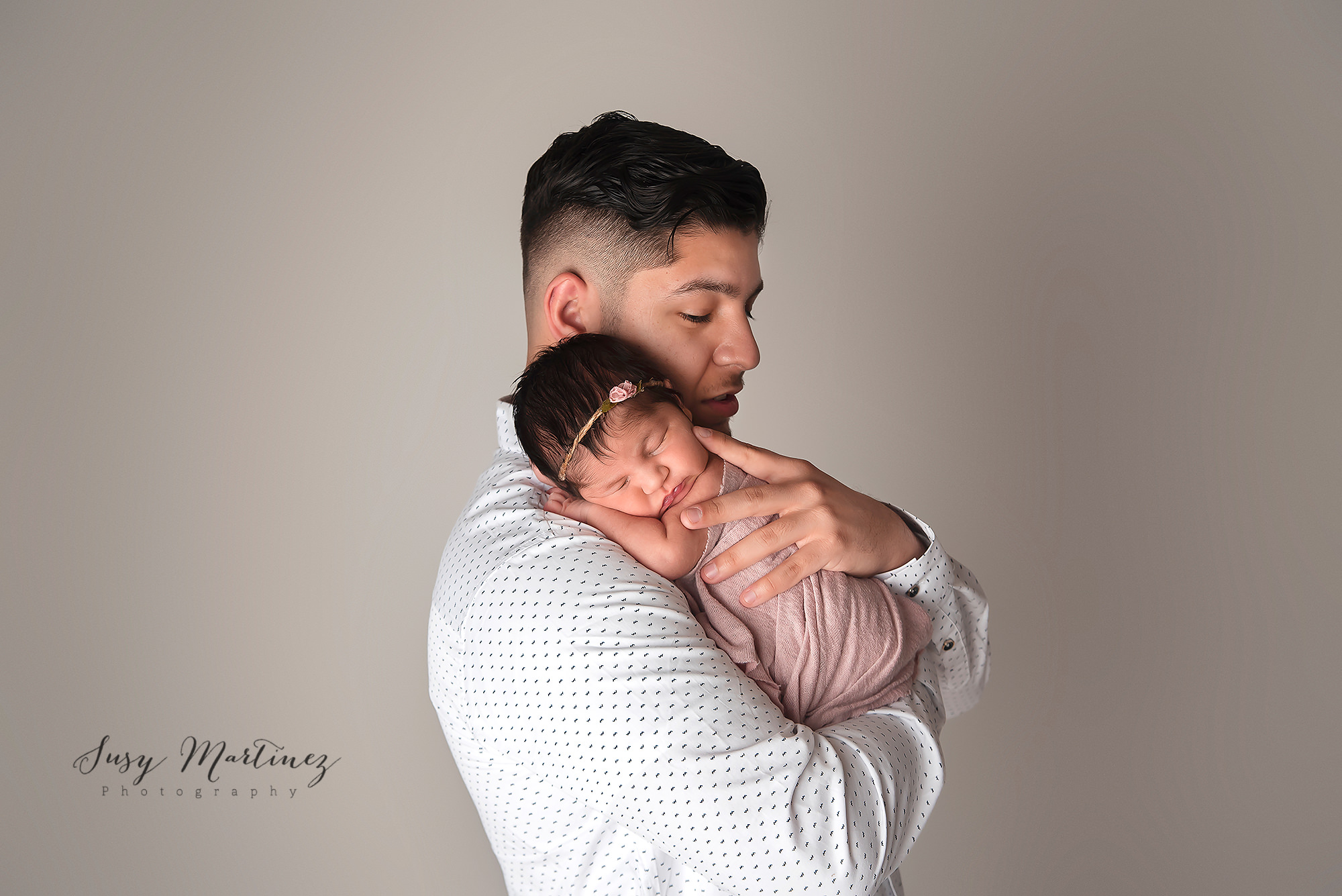 dad holds baby girl during pastel themed newborn session in Las Vegas