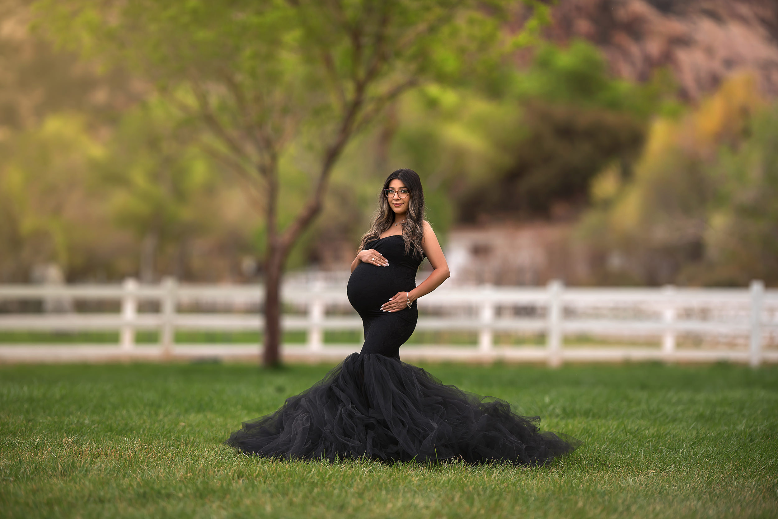 mom stands holding baby belly during Spring Mountain Ranch Maternity Session