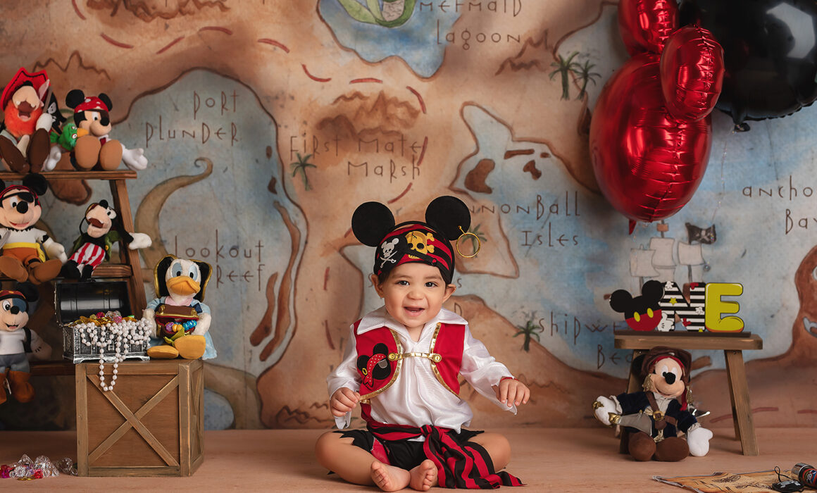 baby in pirate outfit plays during cake smash with Las Vegas photographer